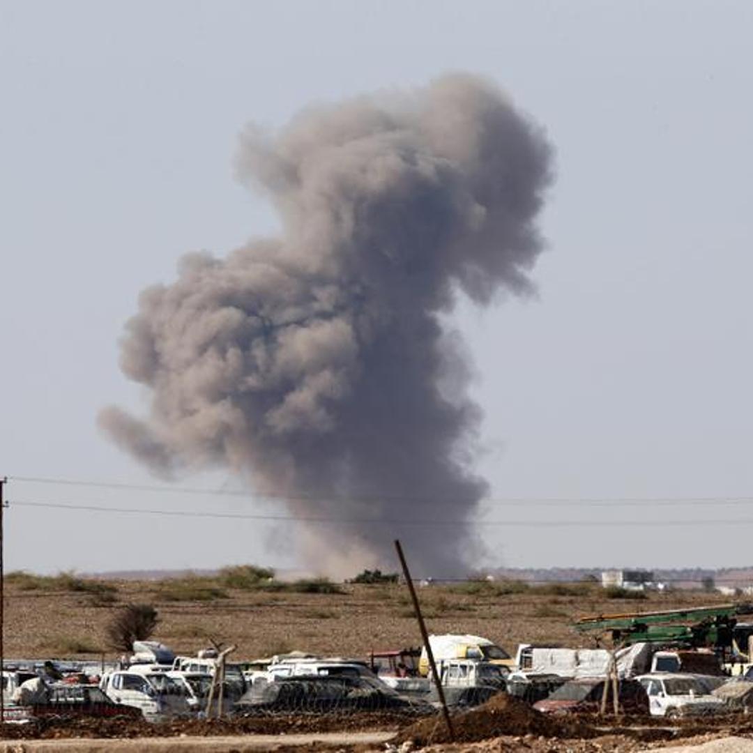 Smoke rises from the Syrian town of Kobani after a war plane carried out an air strike, seen from near the Mursitpinar border crossing on the Turkish-Syrian border in Suruc