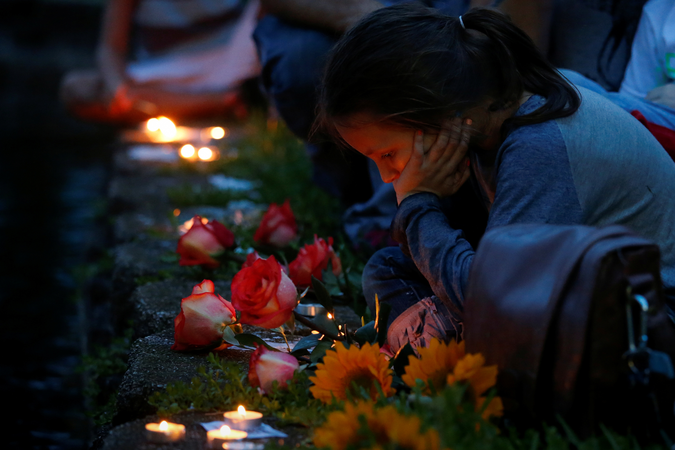A girl takes part in a vigil to commemorate victims of a mass shooting at the Pulse gay night club in Orlando, Florida, U.S., June 12, 2016. REUTERS/Adrees Latif - RTX2FURL