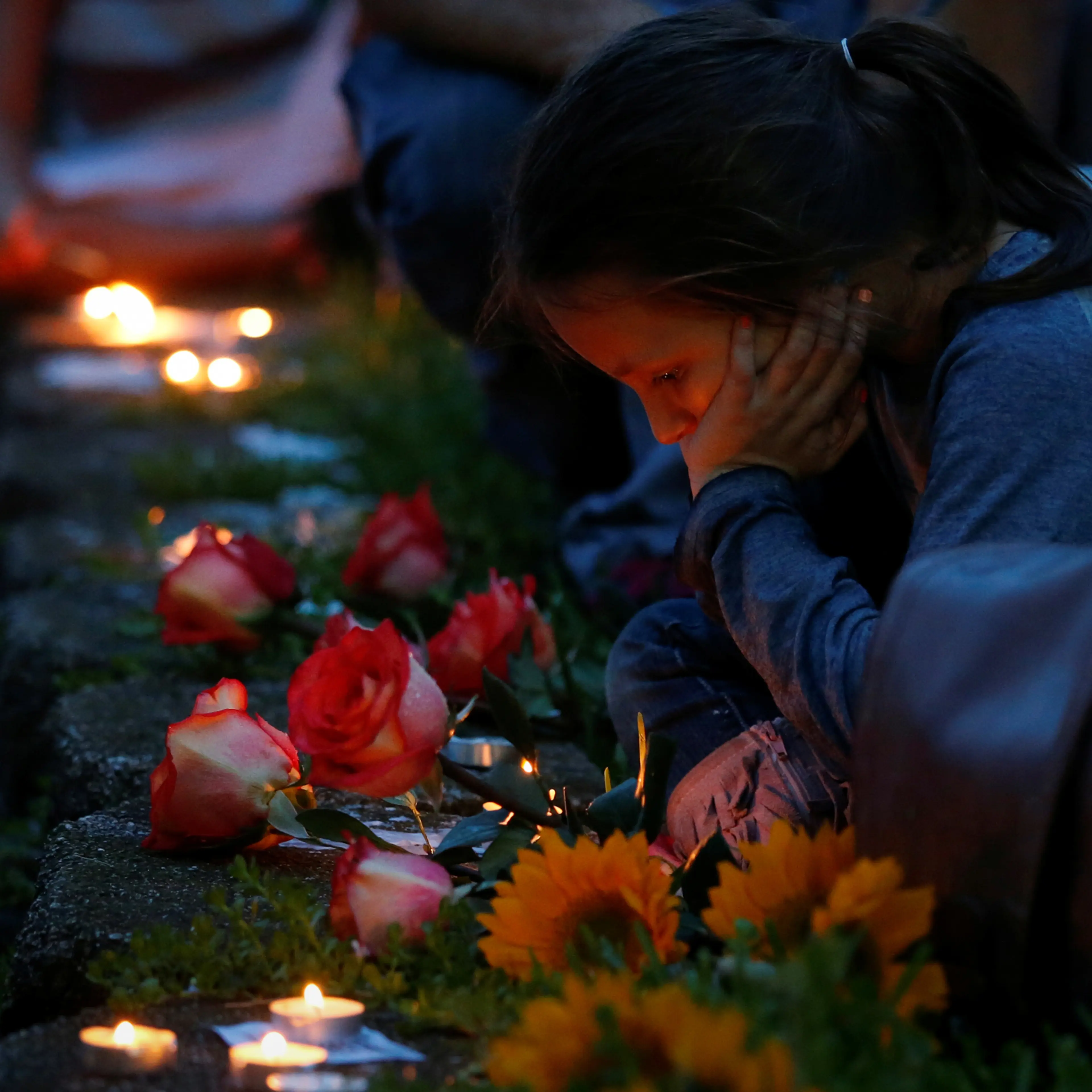 A girl takes part in a vigil to commemorate victims of a mass shooting at the Pulse gay night club in Orlando, Florida, U.S., June 12, 2016. REUTERS/Adrees Latif - RTX2FURL