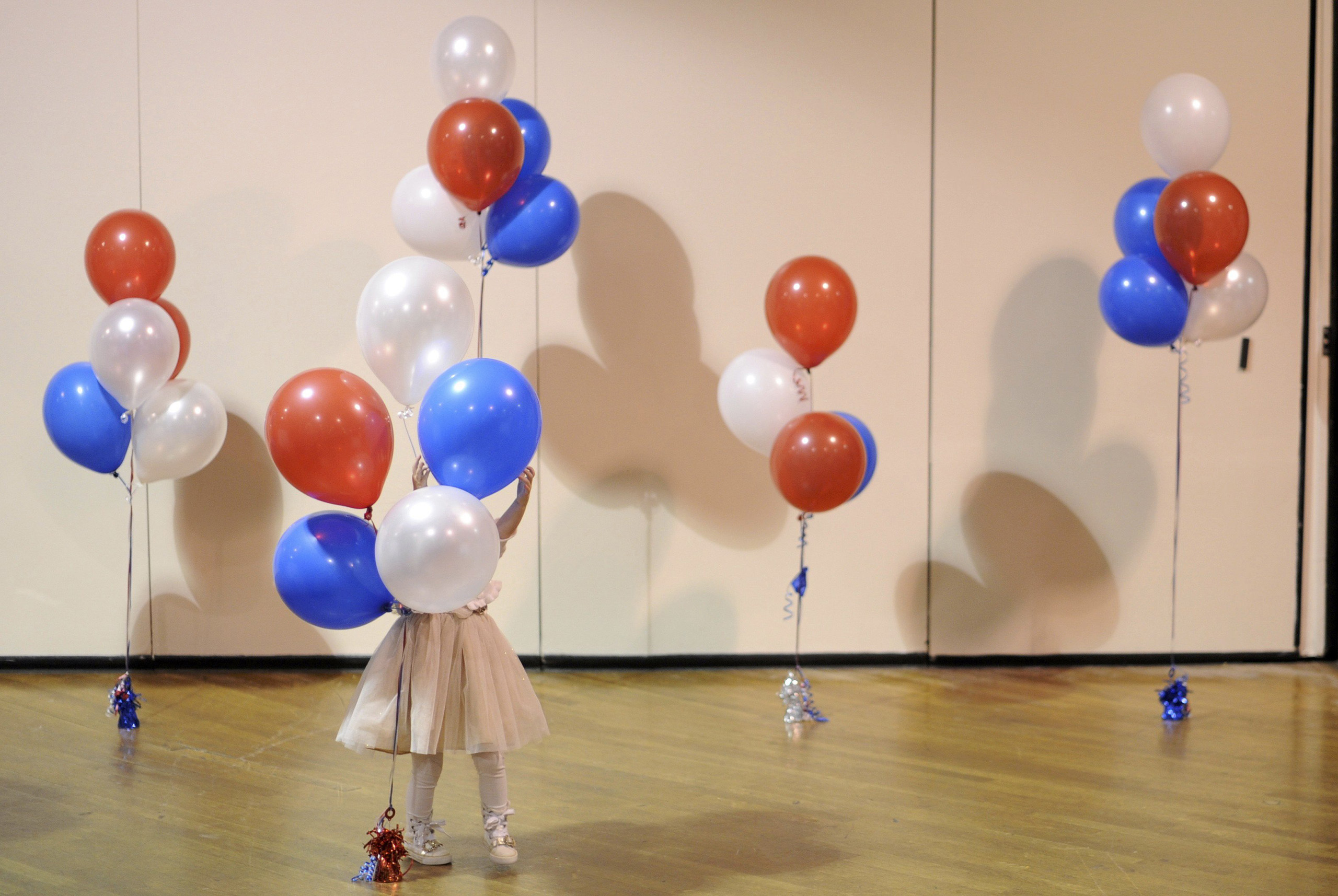 A little girl plays with balloons at Republican U.S. Senate candidate Scott Brown's midterm election night rally in Manchester, New Hampshire on Nov. 4, 2014.
