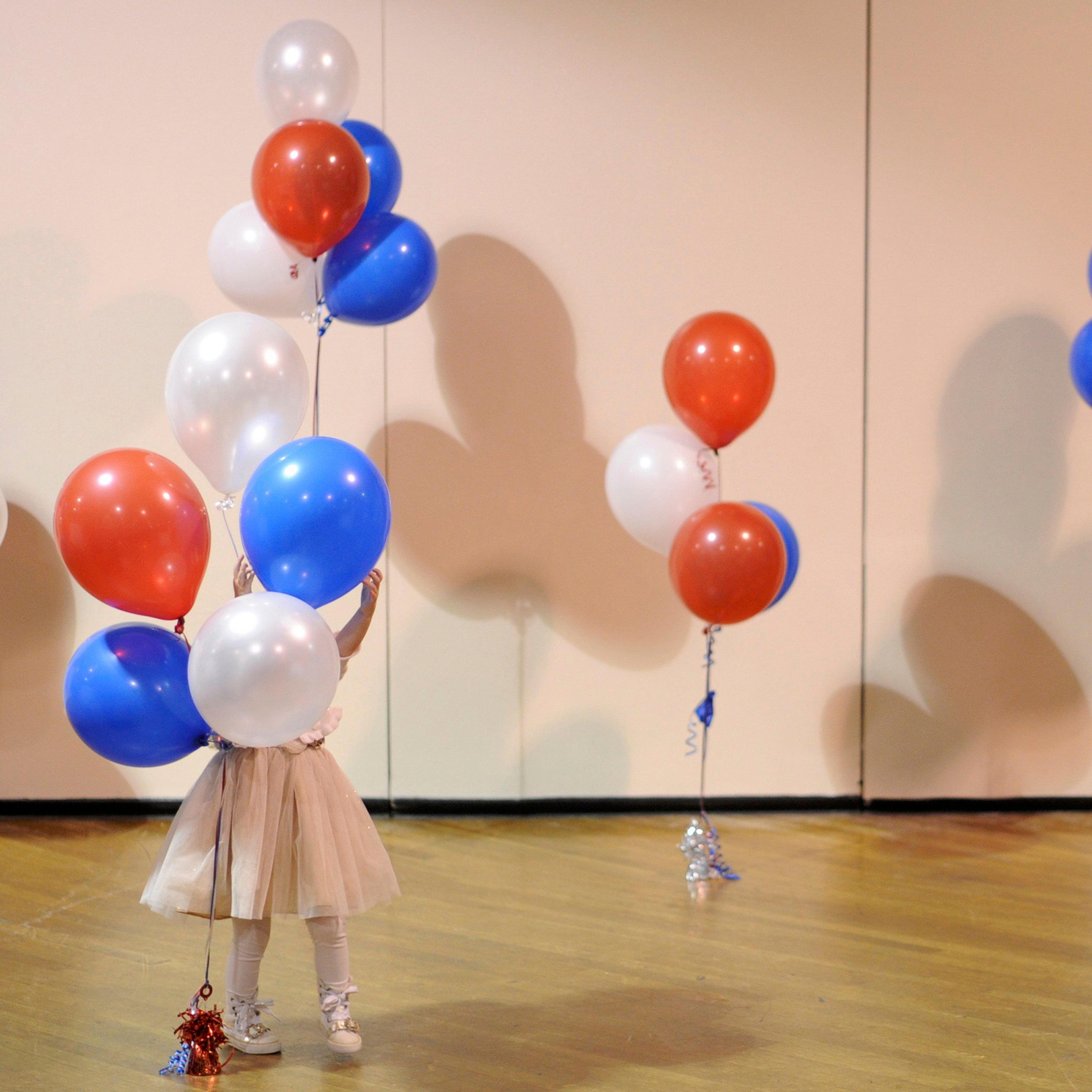 A little girl plays with balloons at Republican U.S. Senate candidate Scott Brown's midterm election night rally in Manchester, New Hampshire on Nov. 4, 2014.
