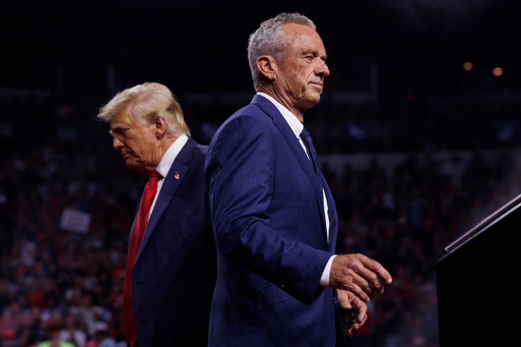 Robert F. Kennedy Jr. walks past President-elect Donald Trump during a campaign rally at Desert Diamond Arena Glendale, Ariz. on Aug. 23. Robert F. Kennedy Jr. walks past Rep
