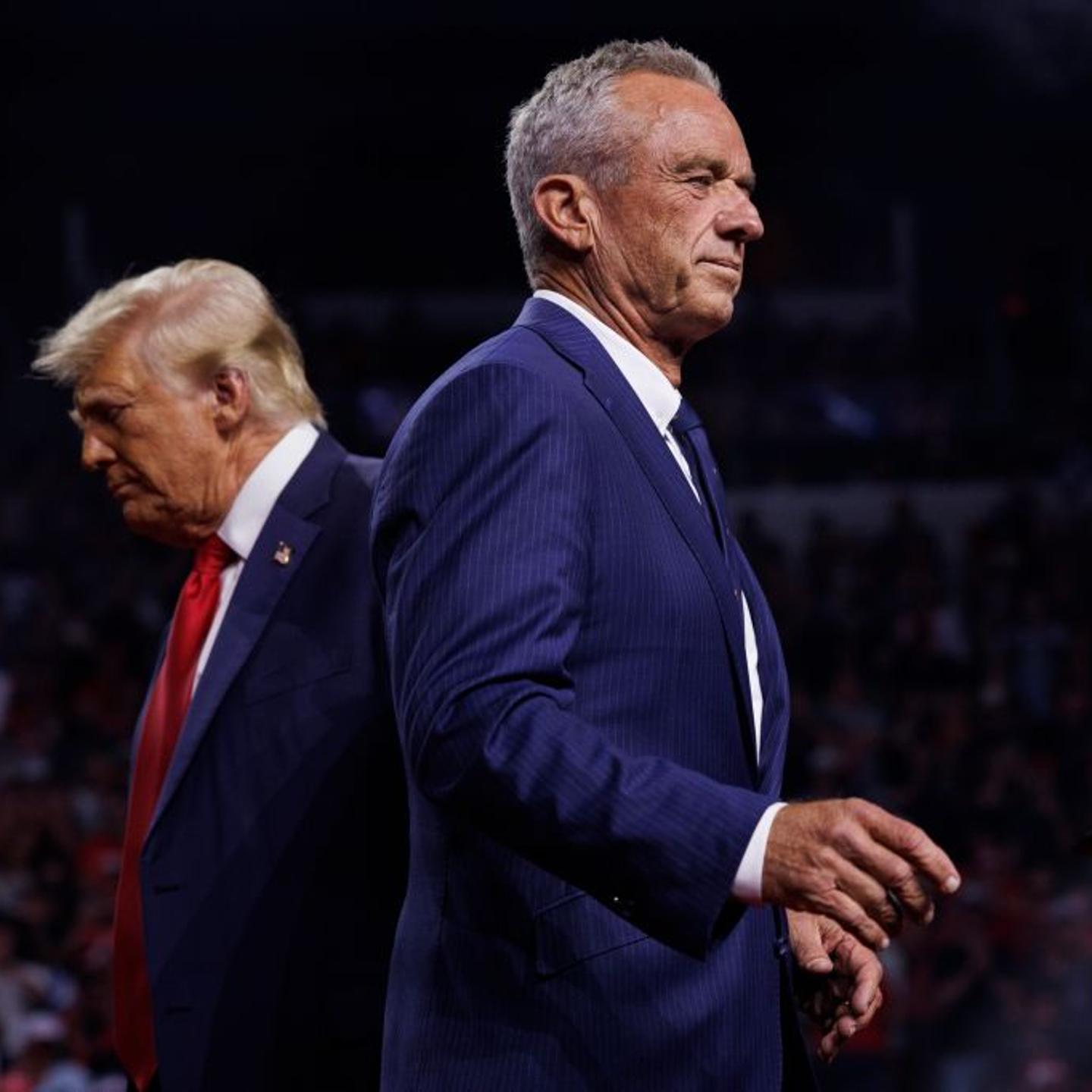 Robert F. Kennedy Jr. walks past President-elect Donald Trump during a campaign rally at Desert Diamond Arena Glendale, Ariz. on Aug. 23. Robert F. Kennedy Jr. walks past Rep