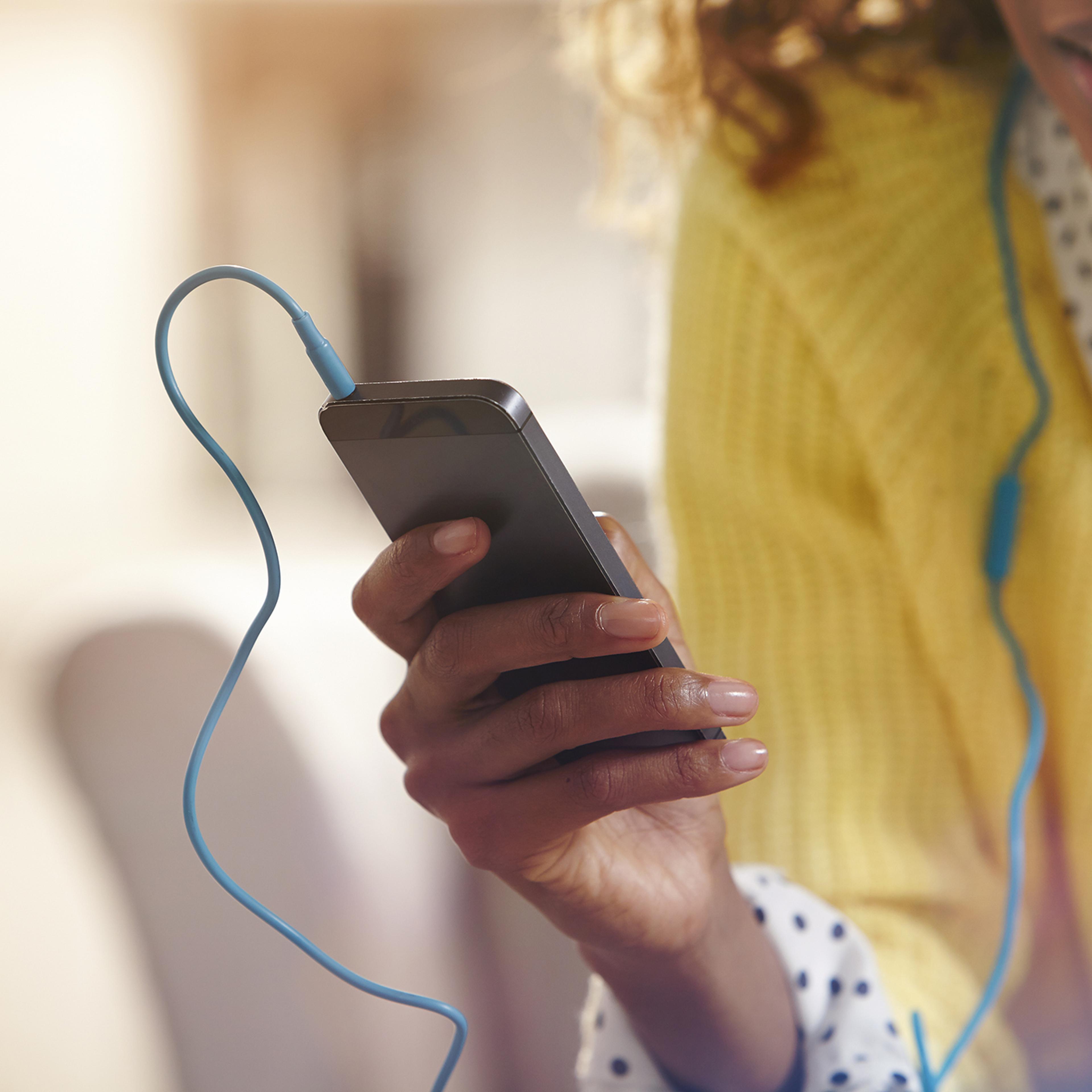 Woman listening to music on her phone.