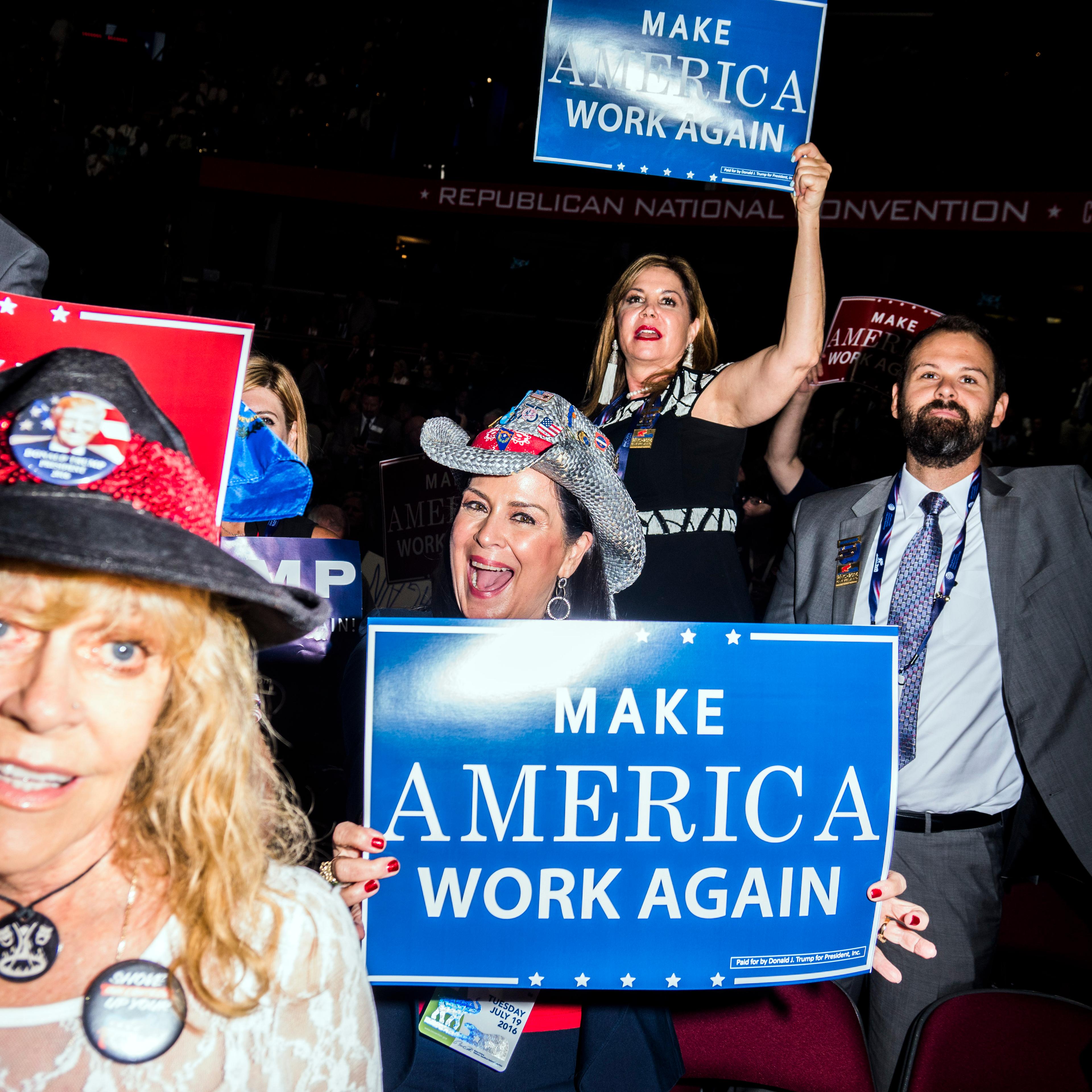 Attendees hold signs at the Republican National Convention in Cleveland on July 19, 2016