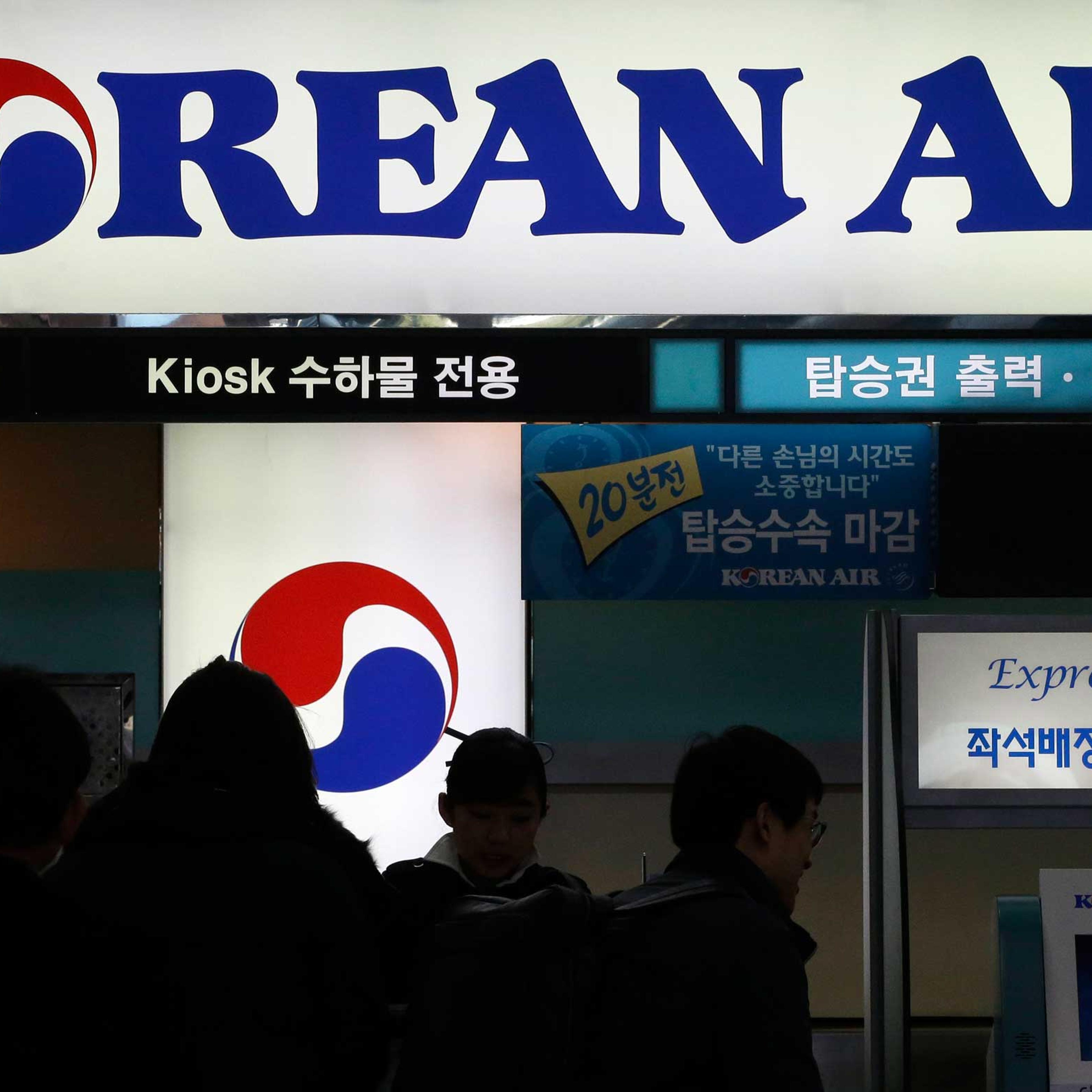 Passengers wait to check in at the domestic check-in desk of Korean Air Lines Co. at Gimpo Airport in Seoul, South Korea, Dec. 2014.