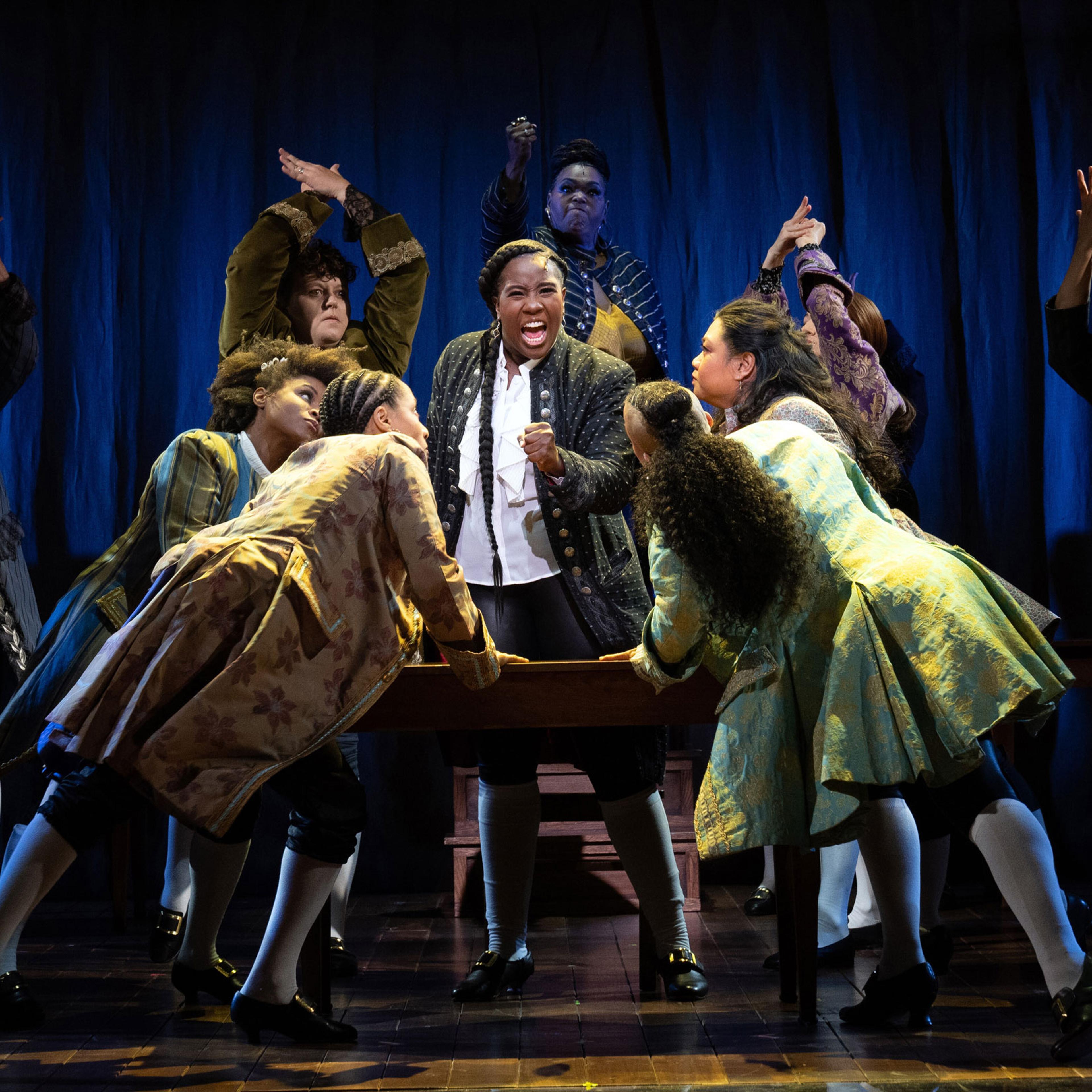 Crystal Lucas-Perry, center, as John Adams in "1776," in which the performers identify as female, transgender and nonbinary, at the American Airlines Theater in New York, Sept. 15, 2022.
