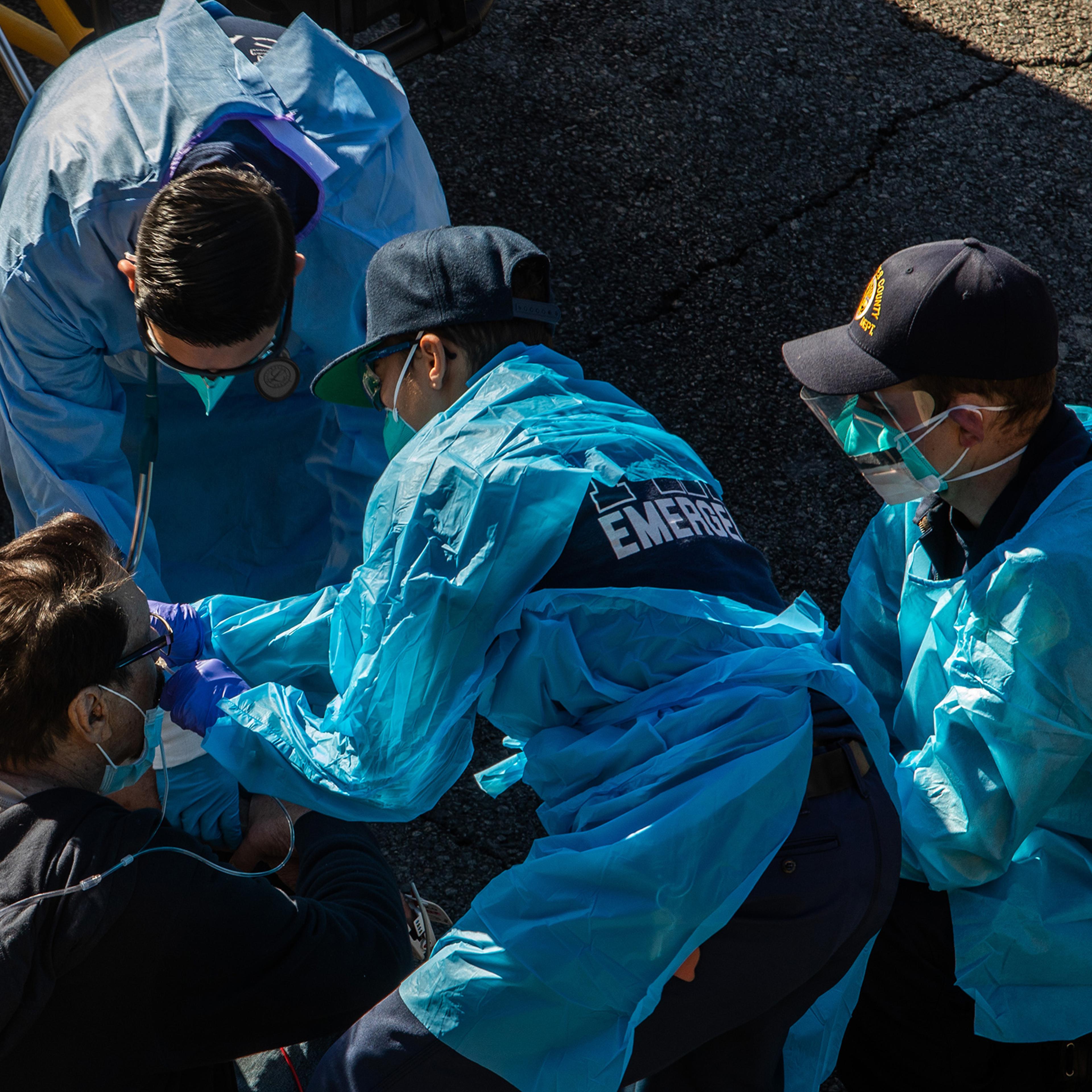 Paramedics give oxygen to a potential COVID-19 patient in Los Angeles County on Dec. 29