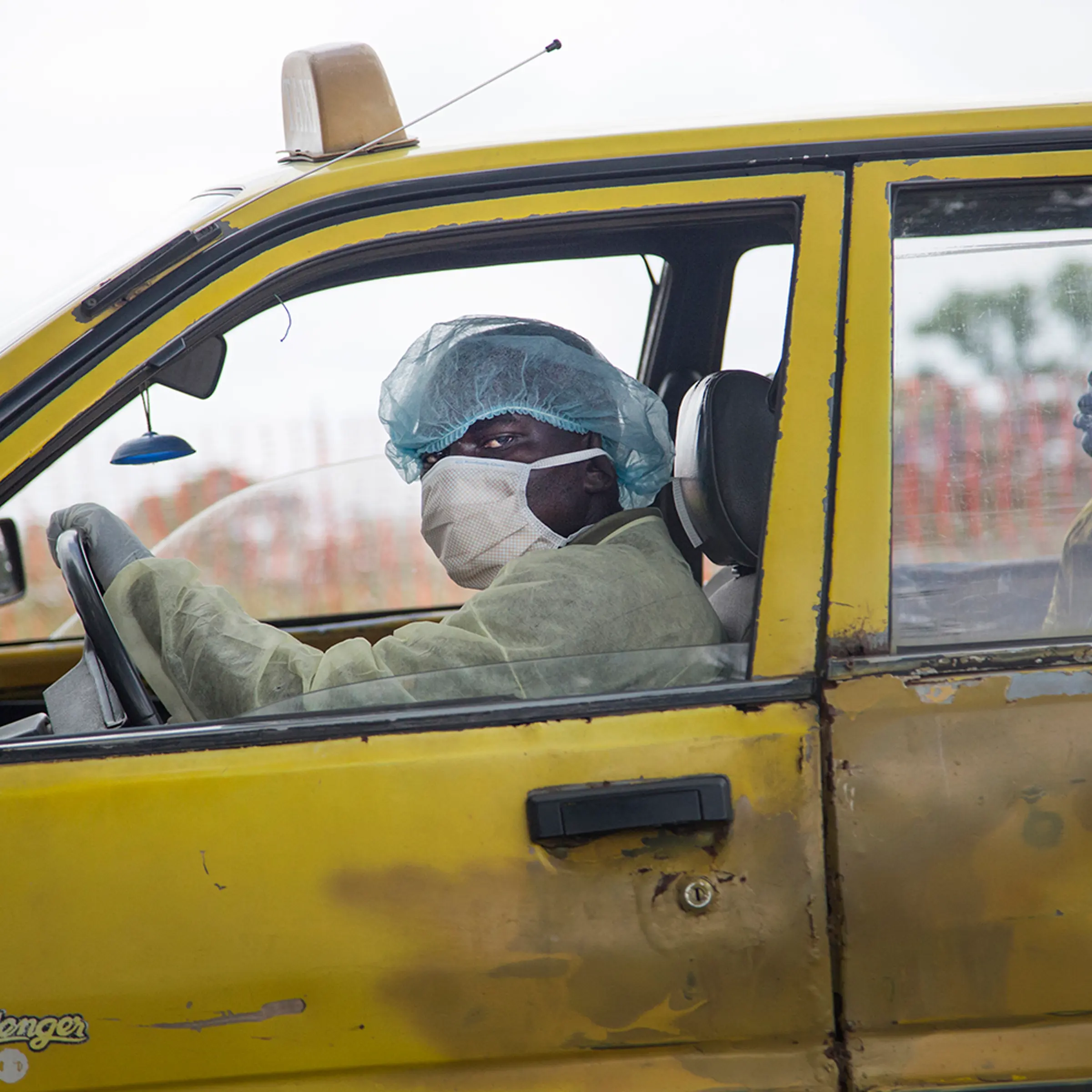 A taxi driver brings a sick woman to an Ebola clinic in Monrovia on Sept. 4.