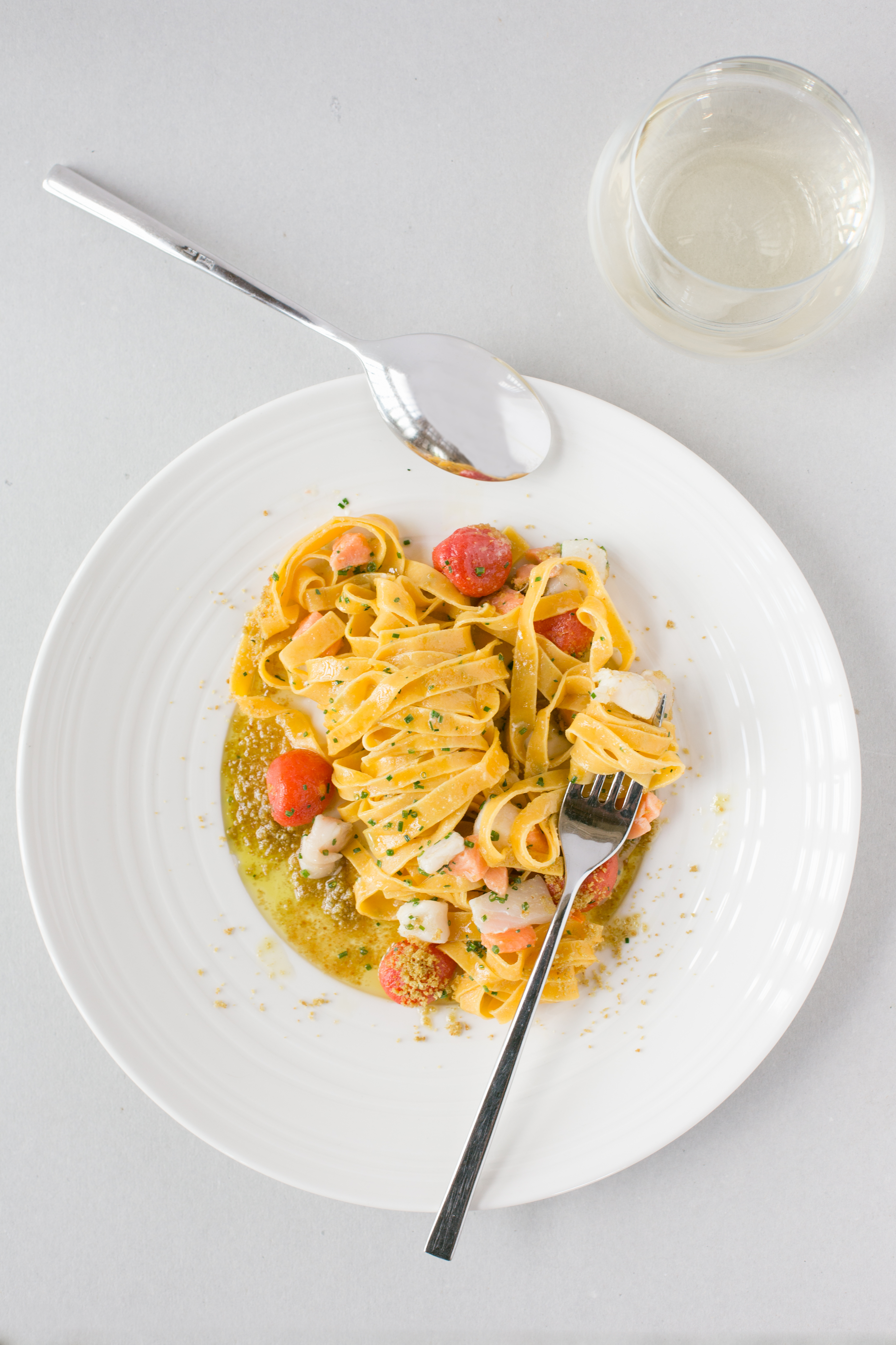 Plate of sea food pappardelle with cherry tomatoes