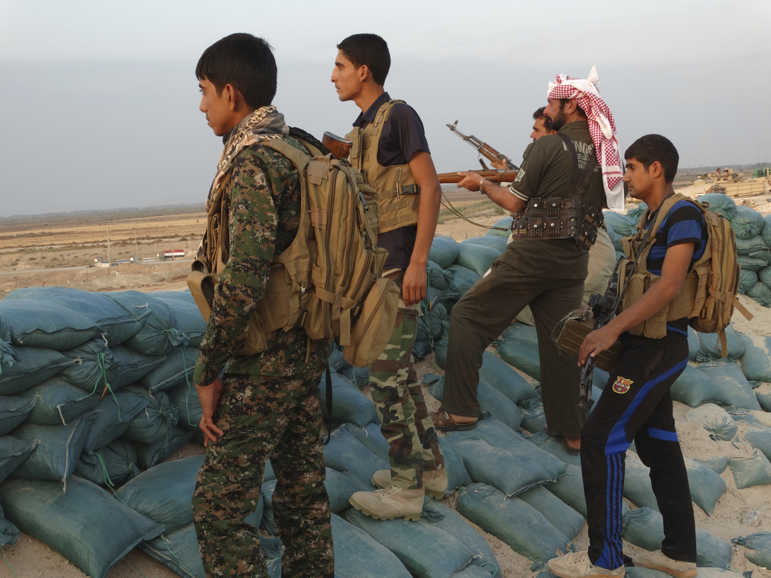 Tribal fighters look on as they take part in an intensive security deployment against Islamic State militants in the town of Amriyat al-Falluja,in Anbar province