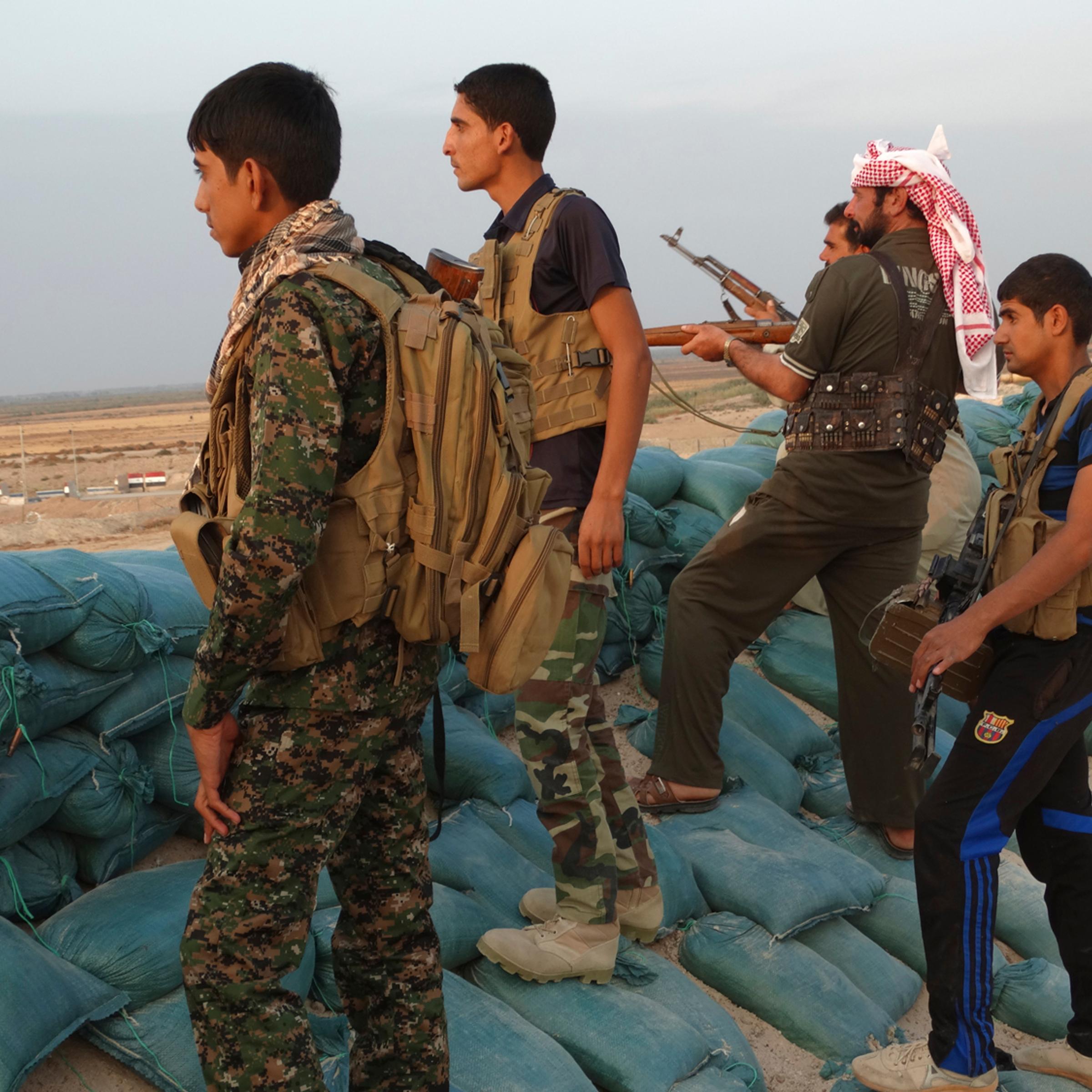 Tribal fighters look on as they take part in an intensive security deployment against Islamic State militants in the town of Amriyat al-Falluja,in Anbar province