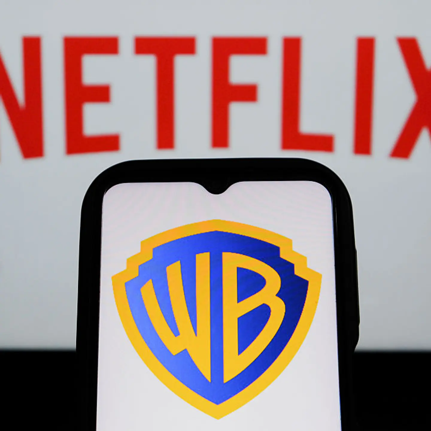 In this photo illustration, the Warner Bros logo is