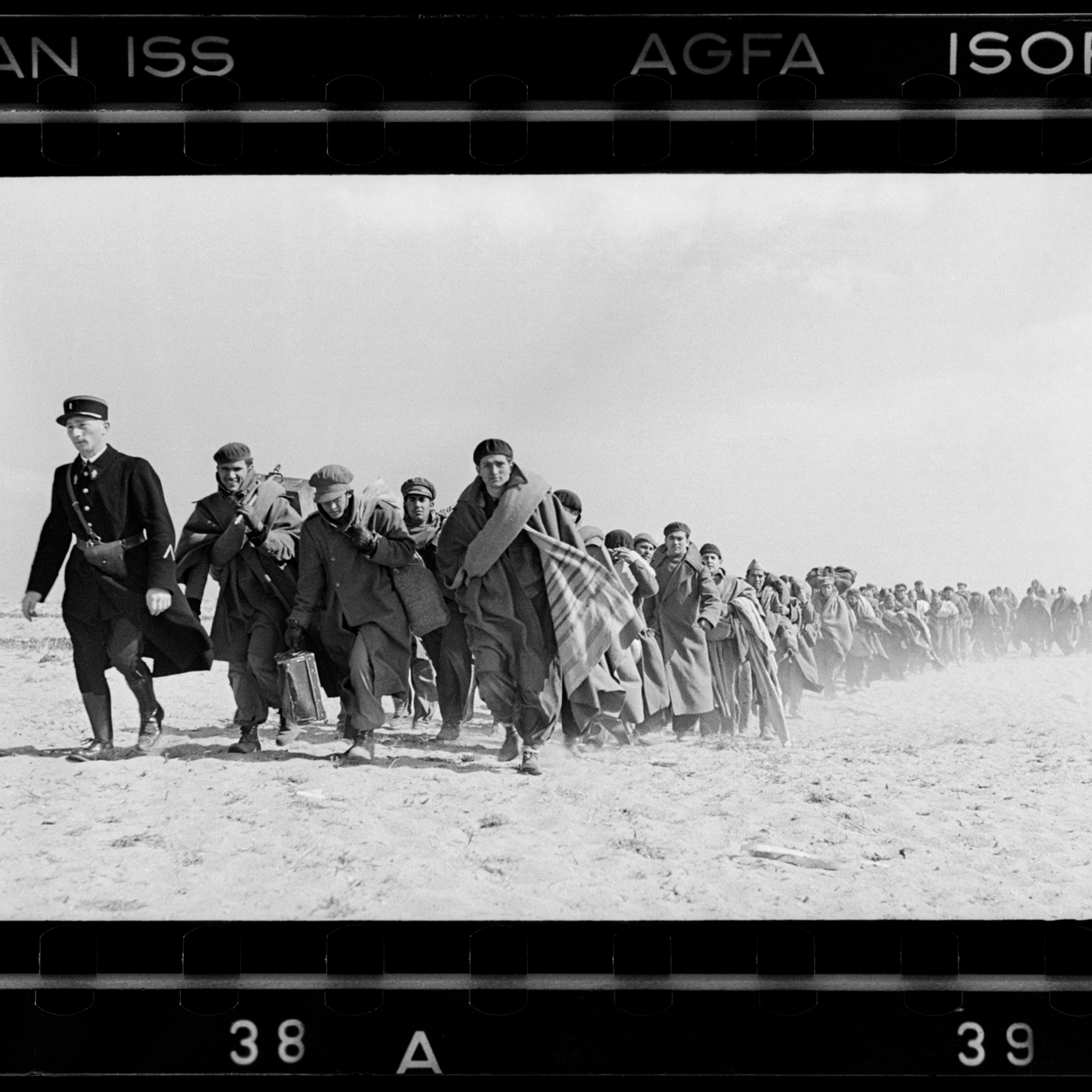 Spanish Republican being led down the beach to a French internment camp, Le Barcarés, France, March 1939