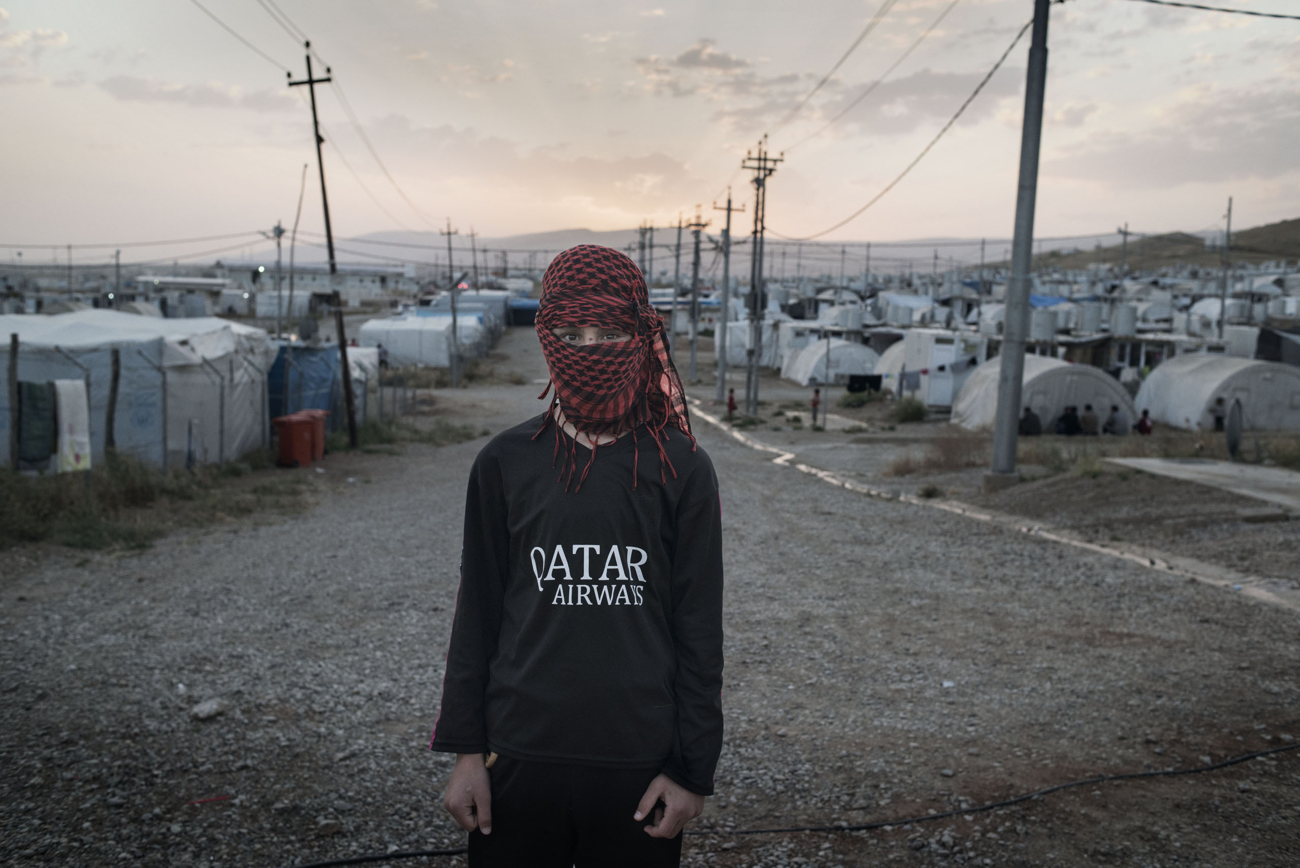 A 16-year old boy at a camp for displaced people outside the city of Dohuk in Iraq's autonomous Kurdish region, May 19, 2016. The teenager was taken captive by ISIS fighters in the summer of 2014 and underwent months of forced military training before es