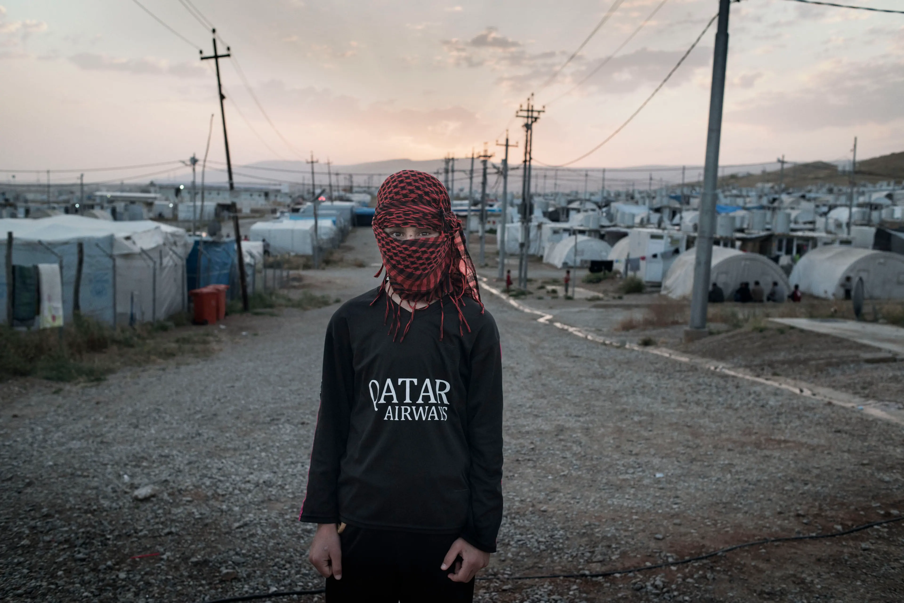 A 16-year old boy at a camp for displaced people outside the city of Dohuk in Iraq's autonomous Kurdish region, May 19, 2016. The teenager was taken captive by ISIS fighters in the summer of 2014 and underwent months of forced military training before es