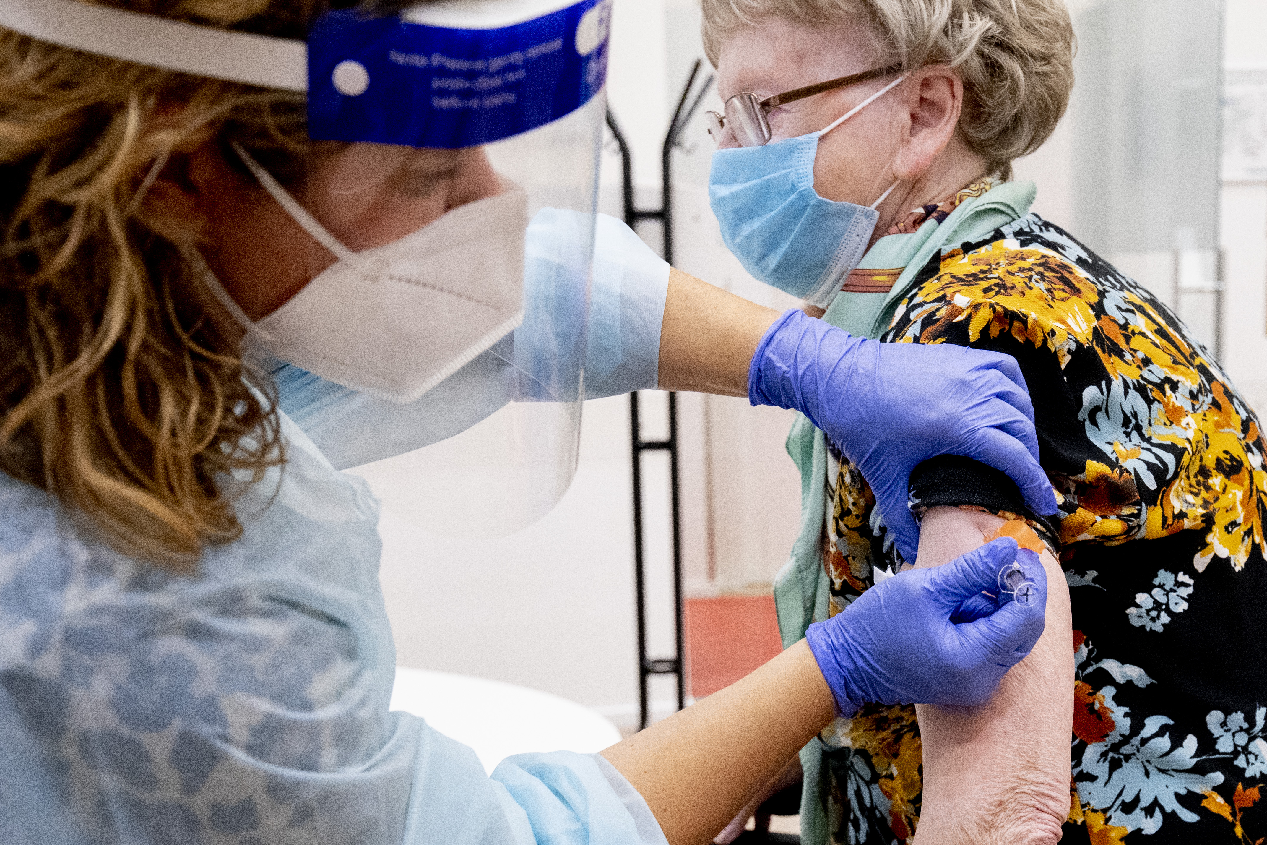 A woman receives an influenza vaccine