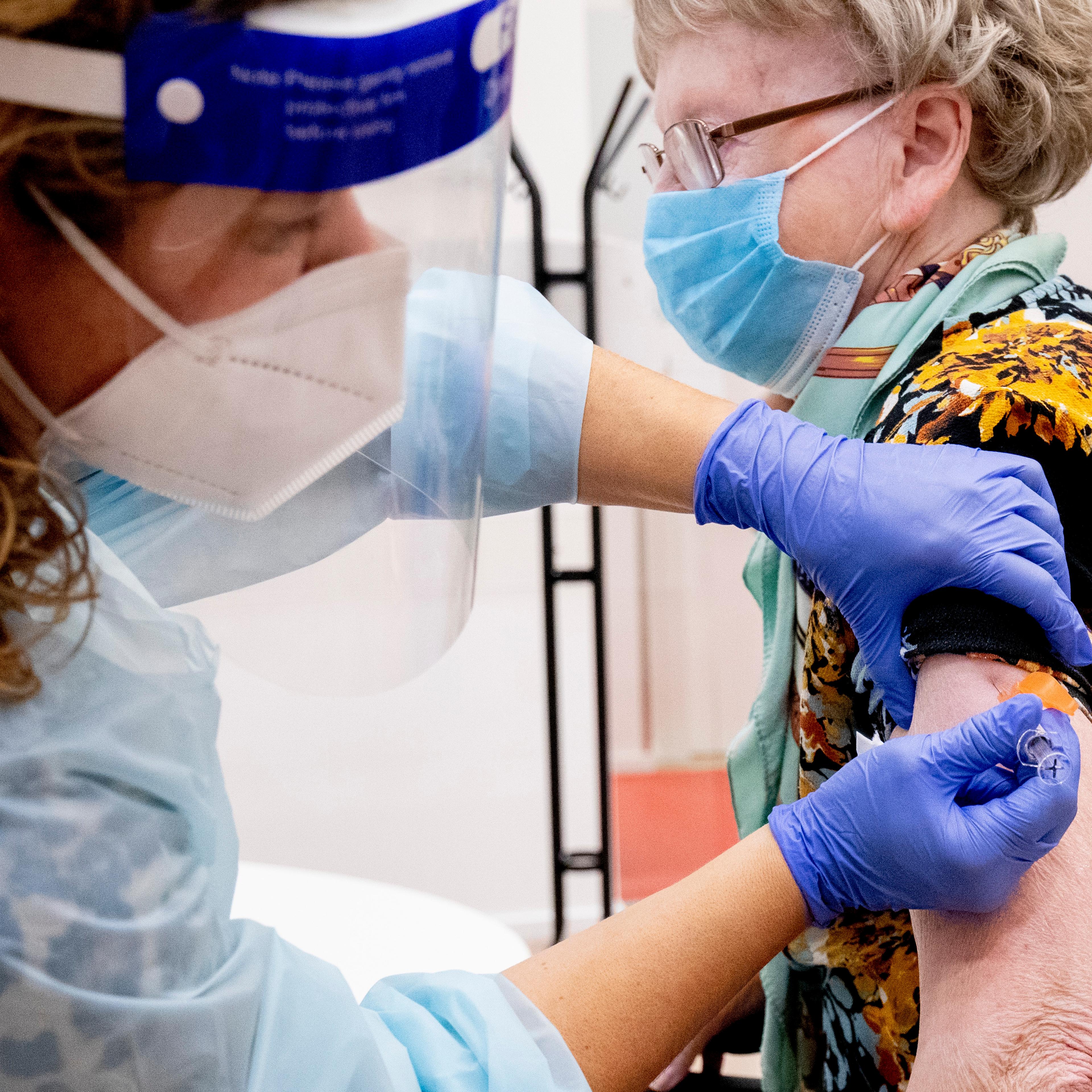 A woman receives an influenza vaccine