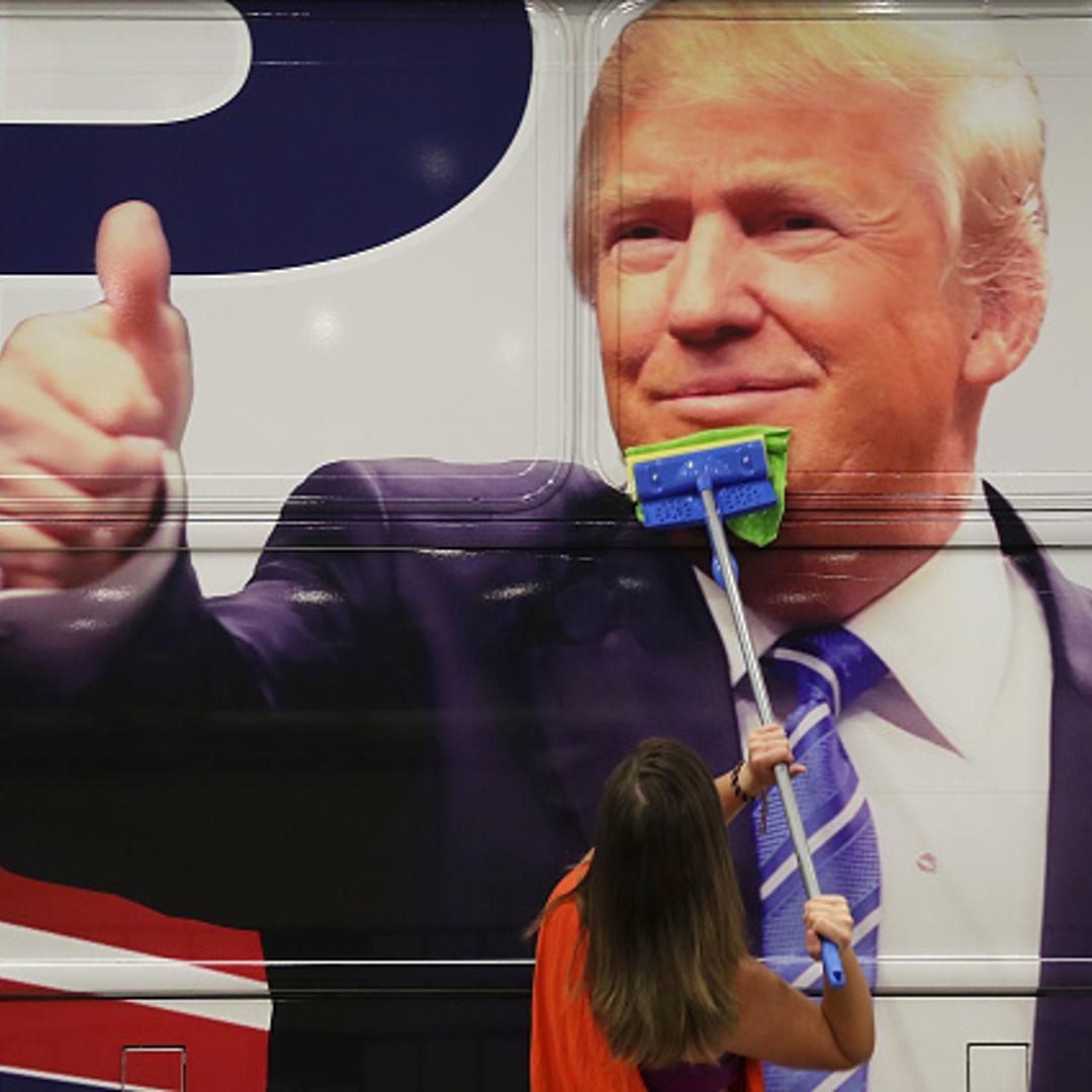 Bailey McDaniel wipes off the side of the campaign bus of Republican presidential candidate Donald Trump before his campaign rally at the South Florida Fair Expo Center on October 13, 2016 in West Palm Beach, Florida.