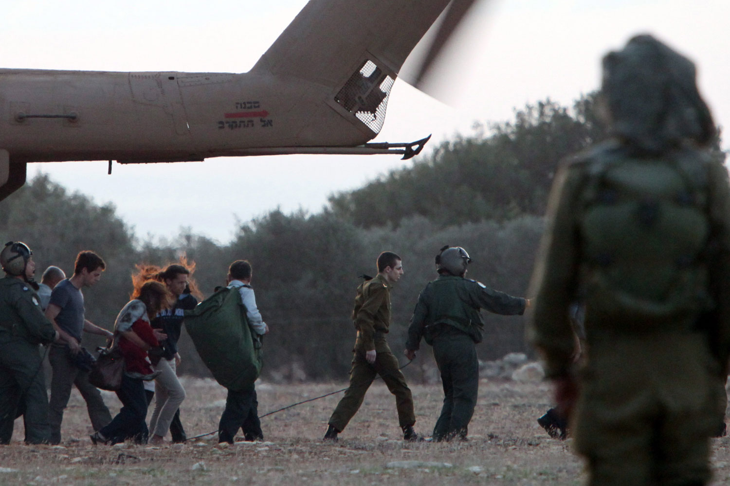 October 18, 2011. In the company of members of his family, Israeli soldier Gilad Shalit is guided from an army helicopter. After being captured by Hamas militants in 2006 and spending five years in captivity in Gaza, Shalit was freed in exchange for the release of more than 1,000 Palestinians from Israeli jails. 