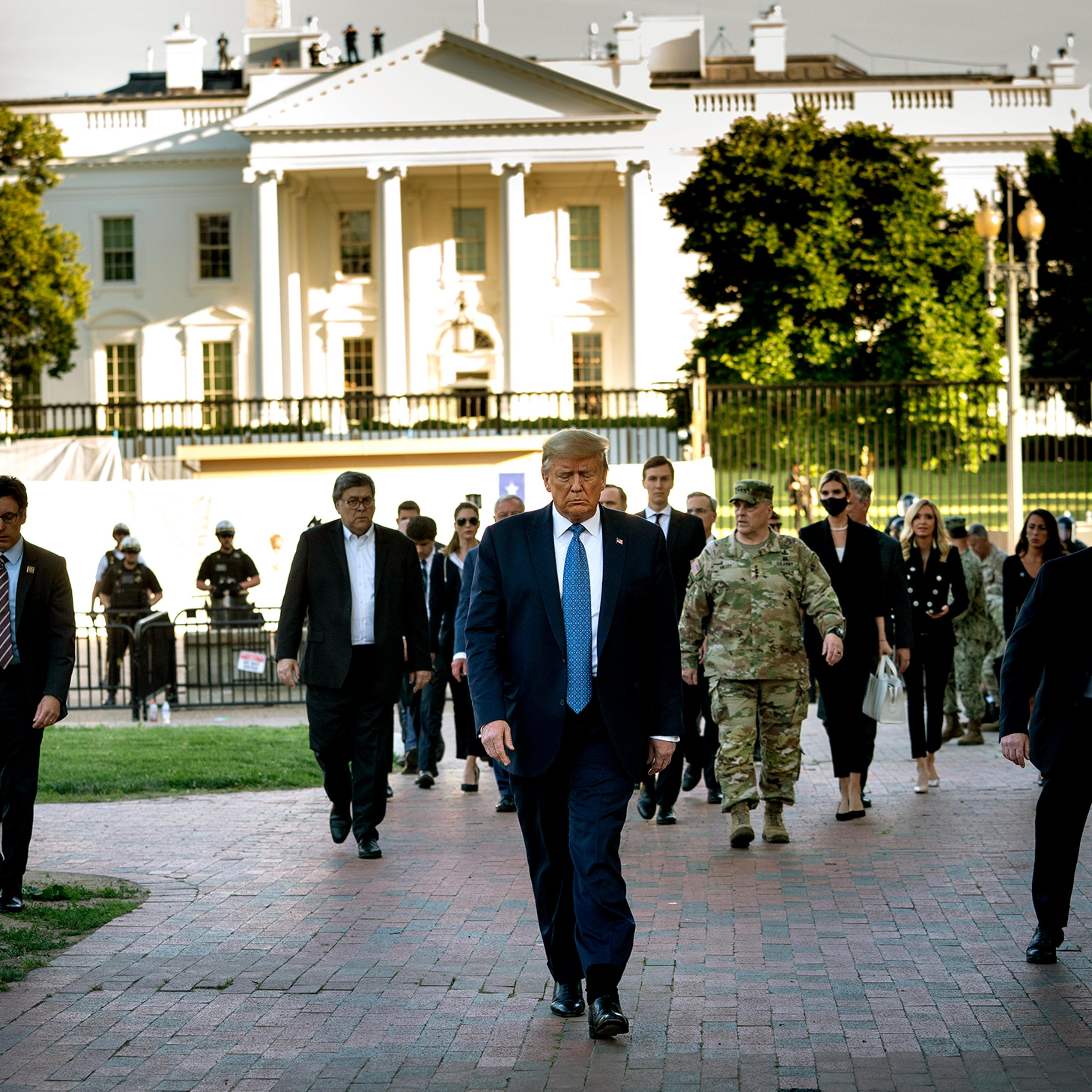 President Donald Trump, trailed by a group that includes Gen. Mark Milley, walks to St. John's Church after security forces cleared Lafayette Square near the White House on June 1, 2020.