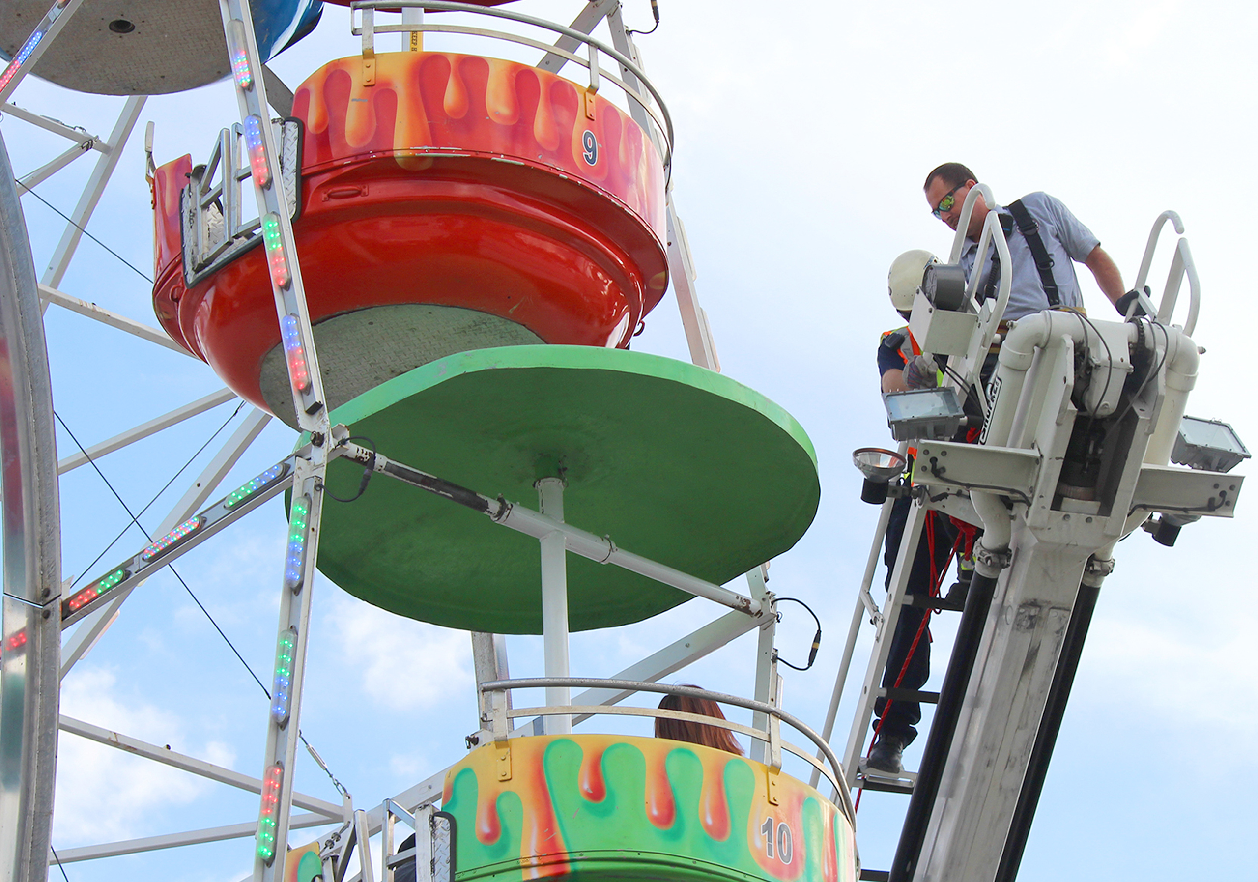 Members of the Greeneville Fire Department help people off the ferris wheel at the Greene County Fair in Greeneville, Tenn. on Aug. 8, 2016.
