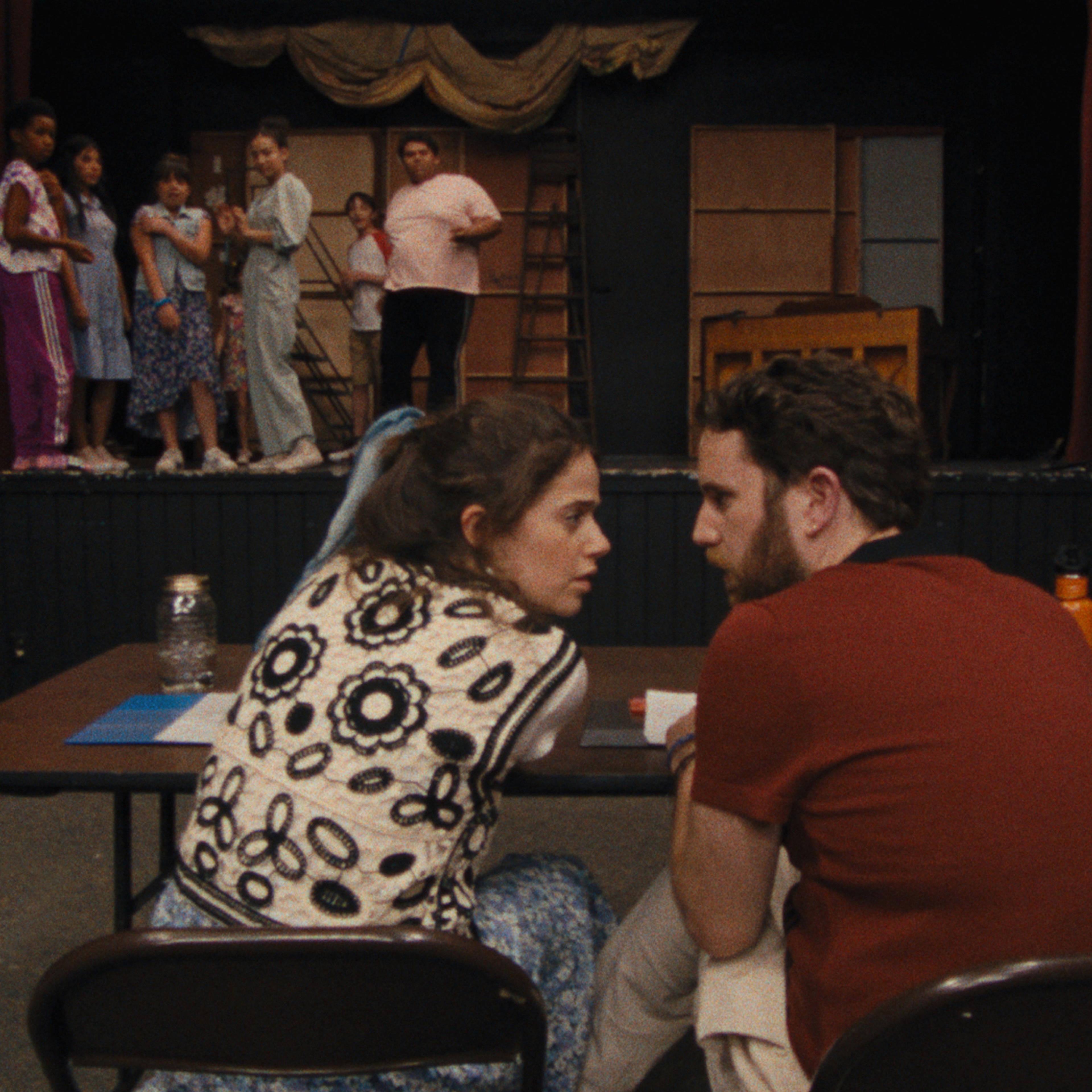Theater instructors Rebecca-Diane (Molly Gordon) and Amos (Ben Platt) confer as a group of campers looks on.