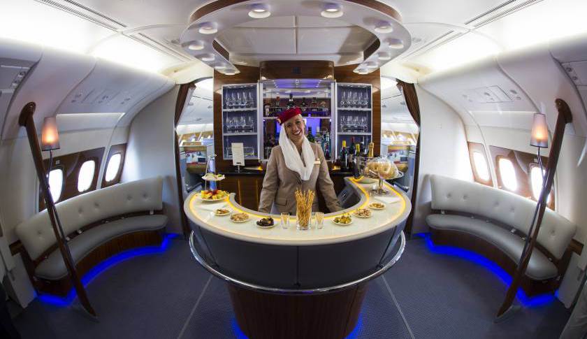 A stewardess poses in the bar of the business class of an Airbus A380 from Emirates.