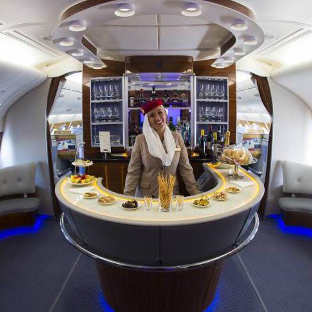 A stewardess poses in the bar of the business class of an Airbus A380 from Emirates.