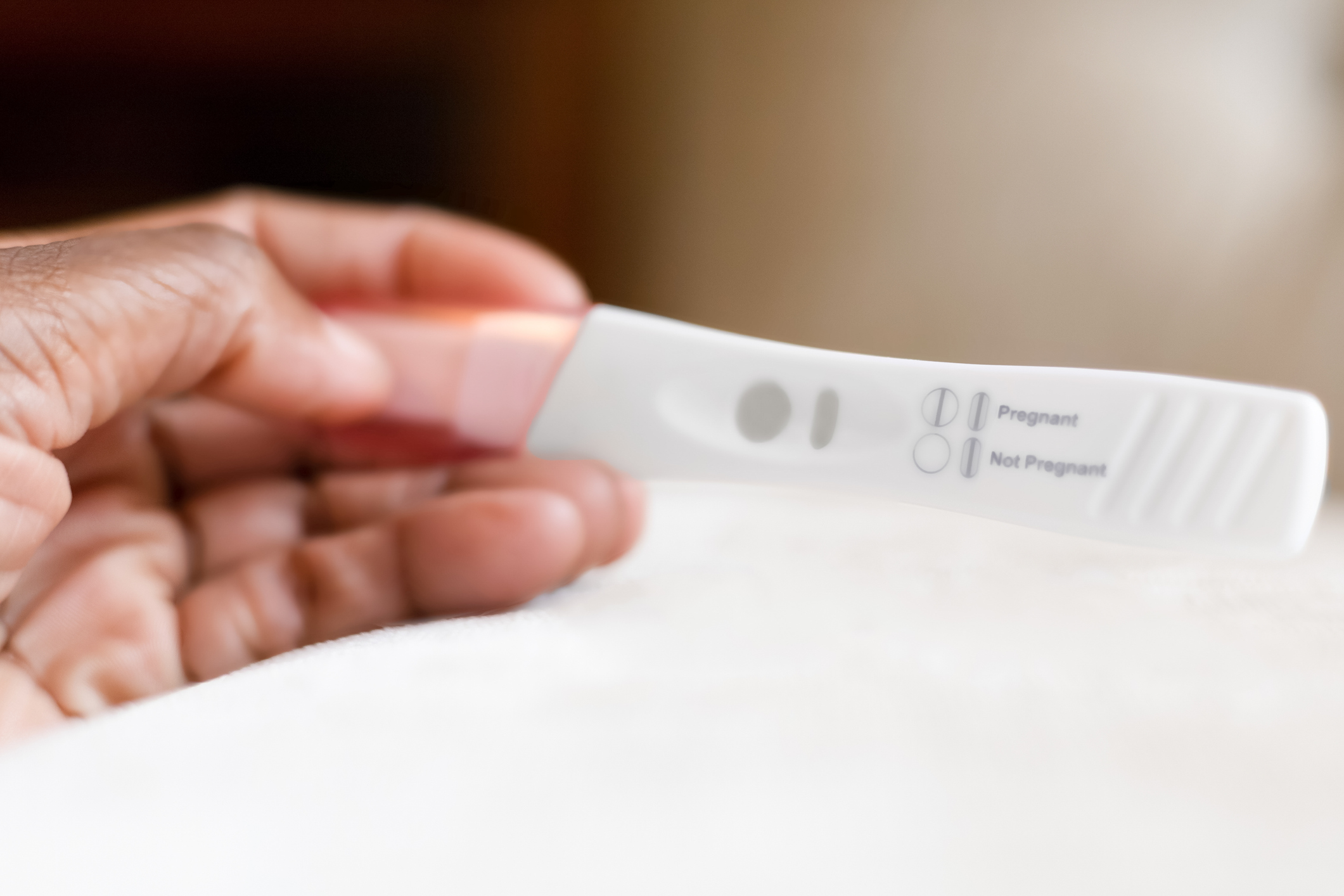 Person reading the results of an at-home pregnancy test