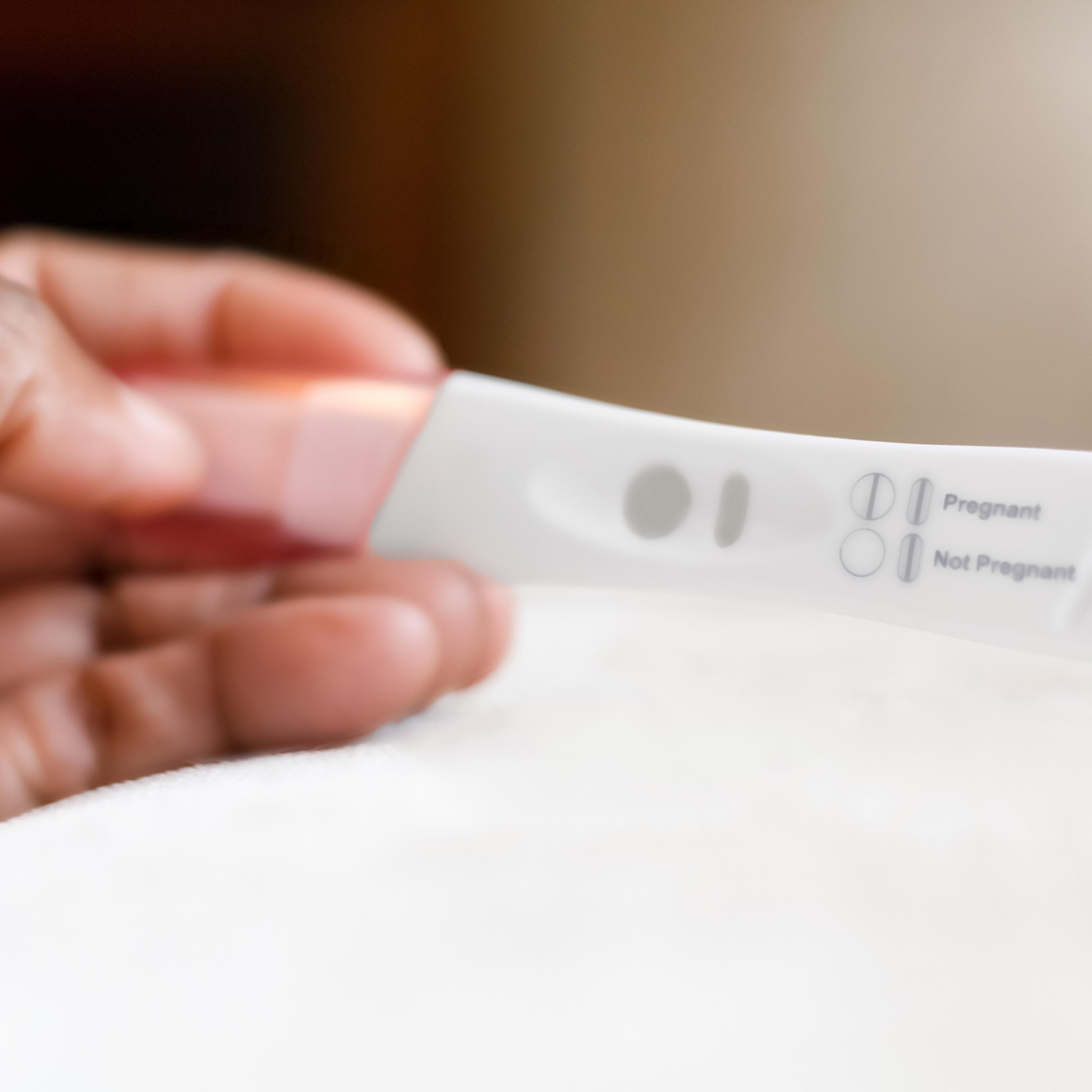 Person reading the results of an at-home pregnancy test