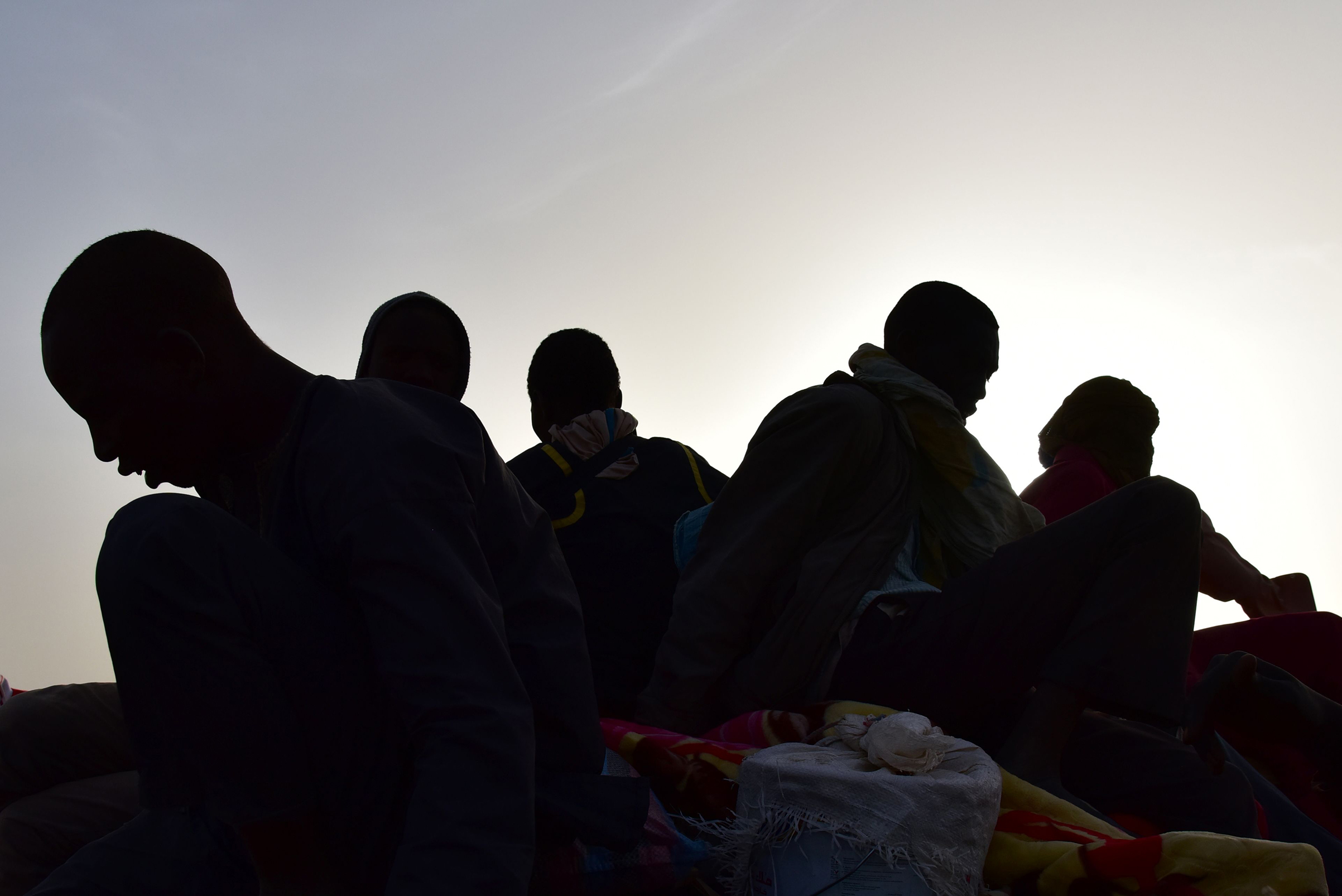 A group of migrants who made a bid to reach Europe but turned back in Libya due to armed groups are shown in a pickup truck in Agadez, northern Niger, on March 31, 2017.