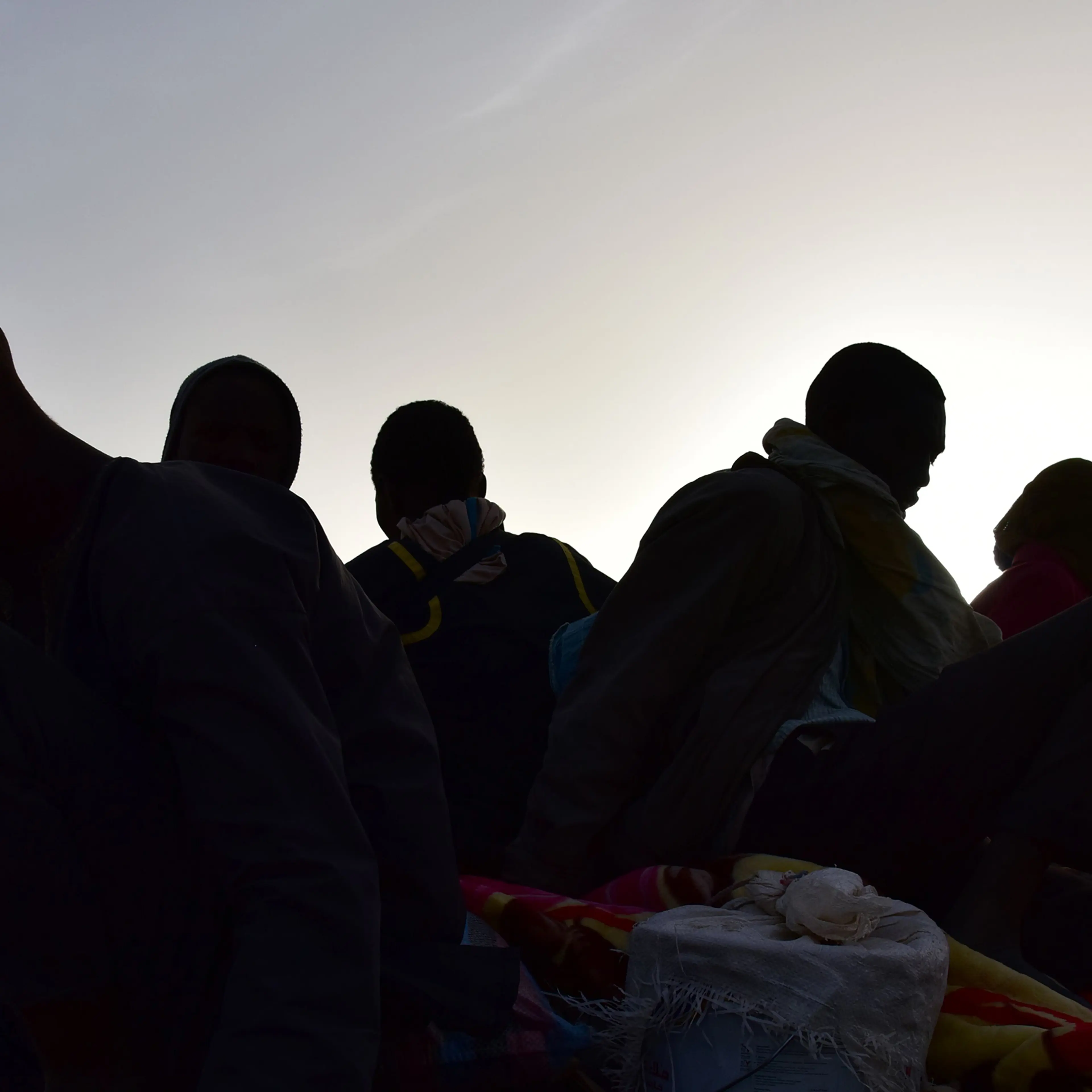 A group of migrants who made a bid to reach Europe but turned back in Libya due to armed groups are shown in a pickup truck in Agadez, northern Niger, on March 31, 2017.
