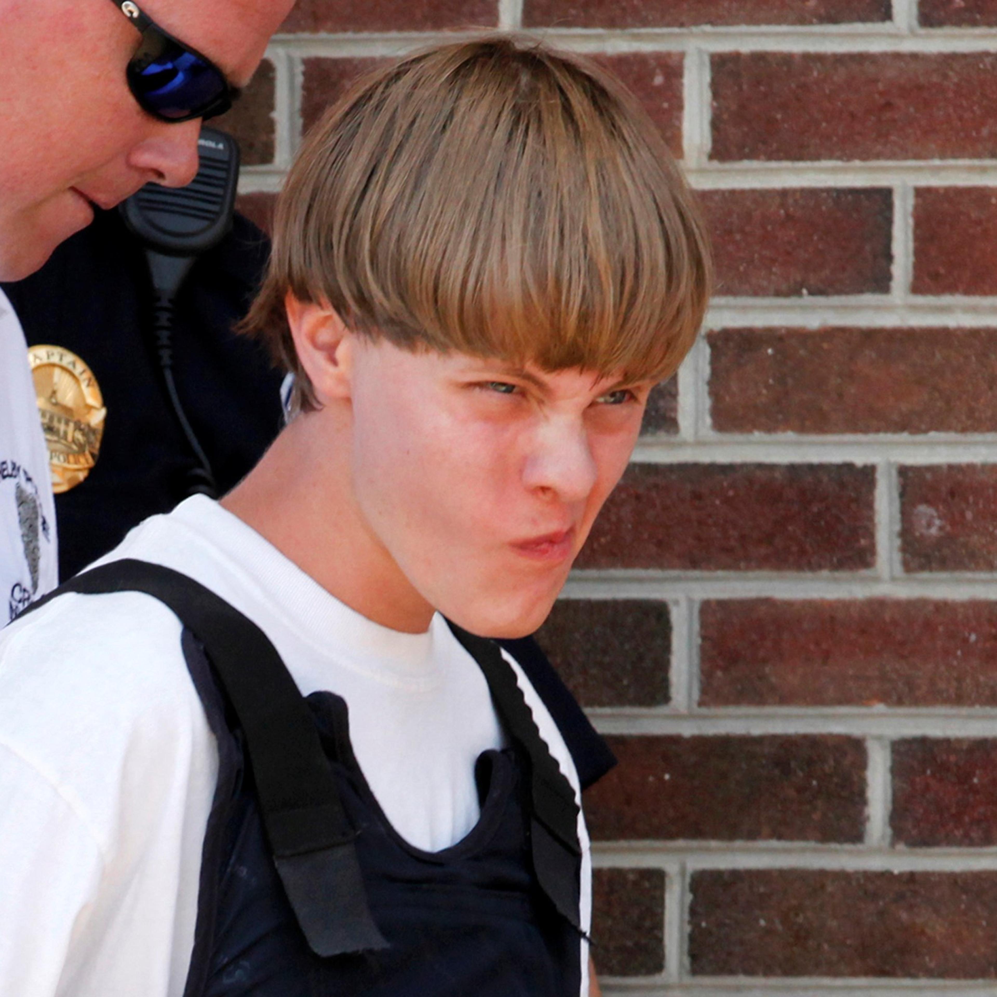 File photo of police leading suspected shooter Dylann Roof into the courthouse in Shelby