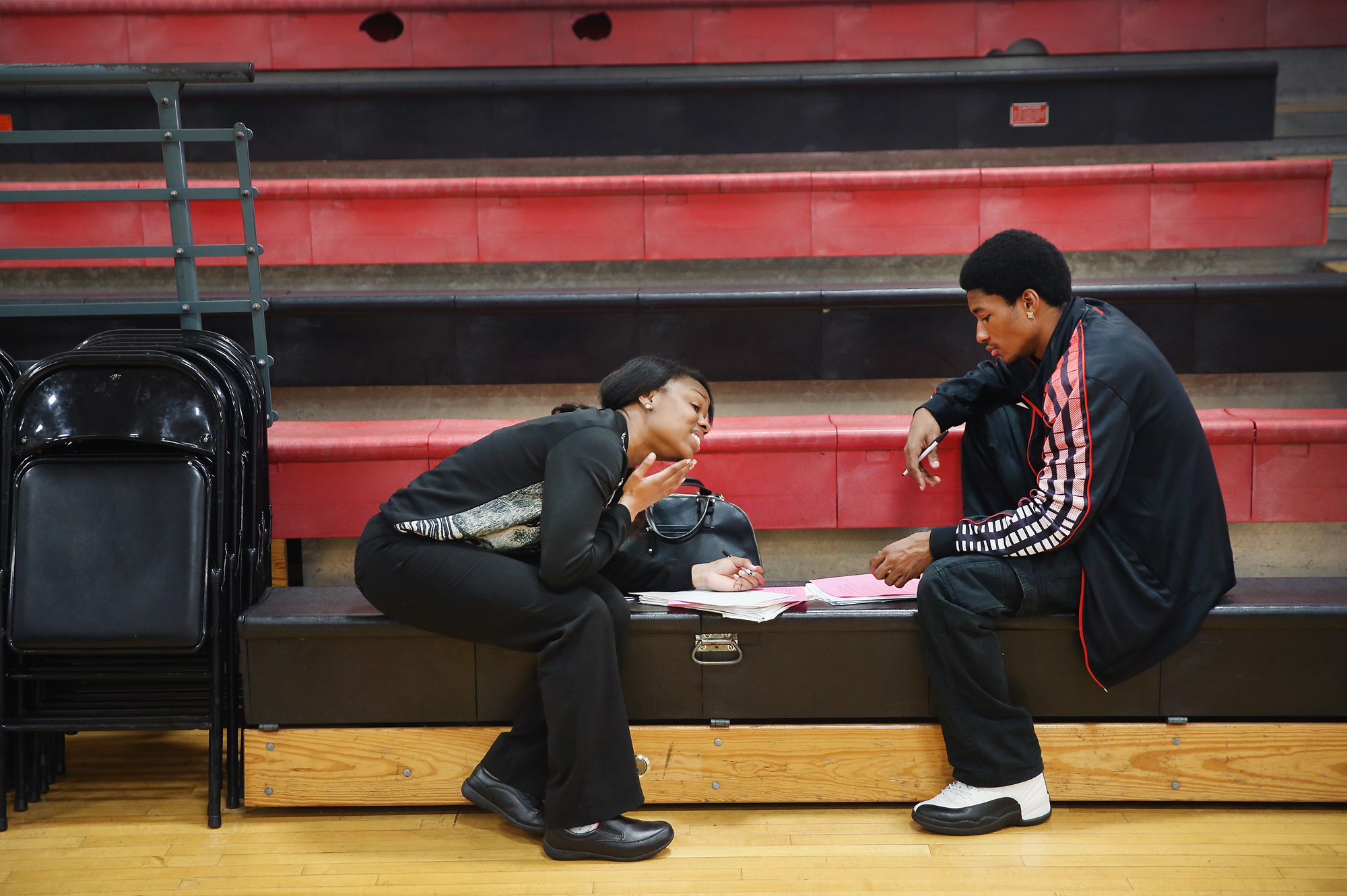 Tamara Lane and Stedman Lewis fill out applications at a job fair on June 12, 2014 in Chicago, Ill.