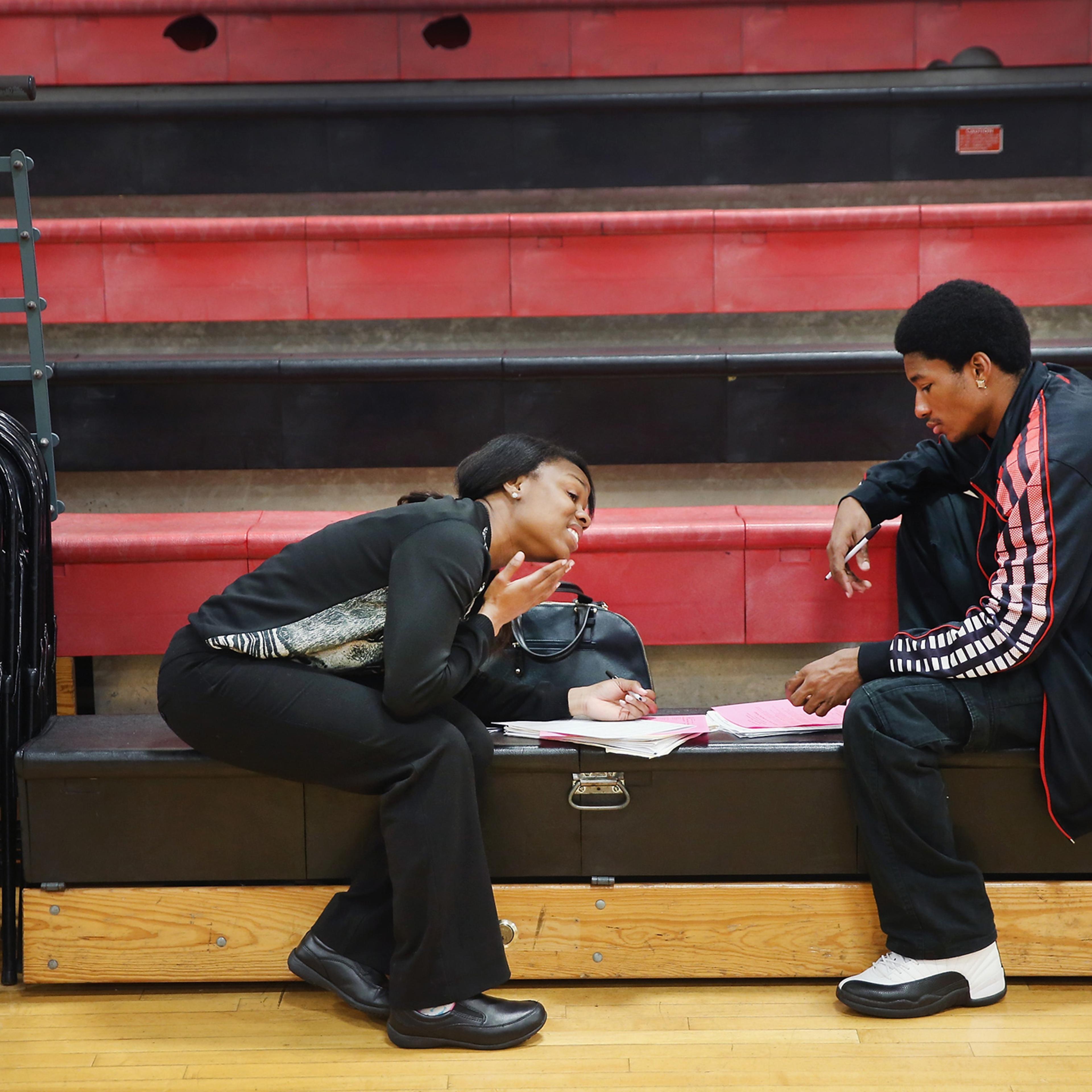 Tamara Lane and Stedman Lewis fill out applications at a job fair on June 12, 2014 in Chicago, Ill.