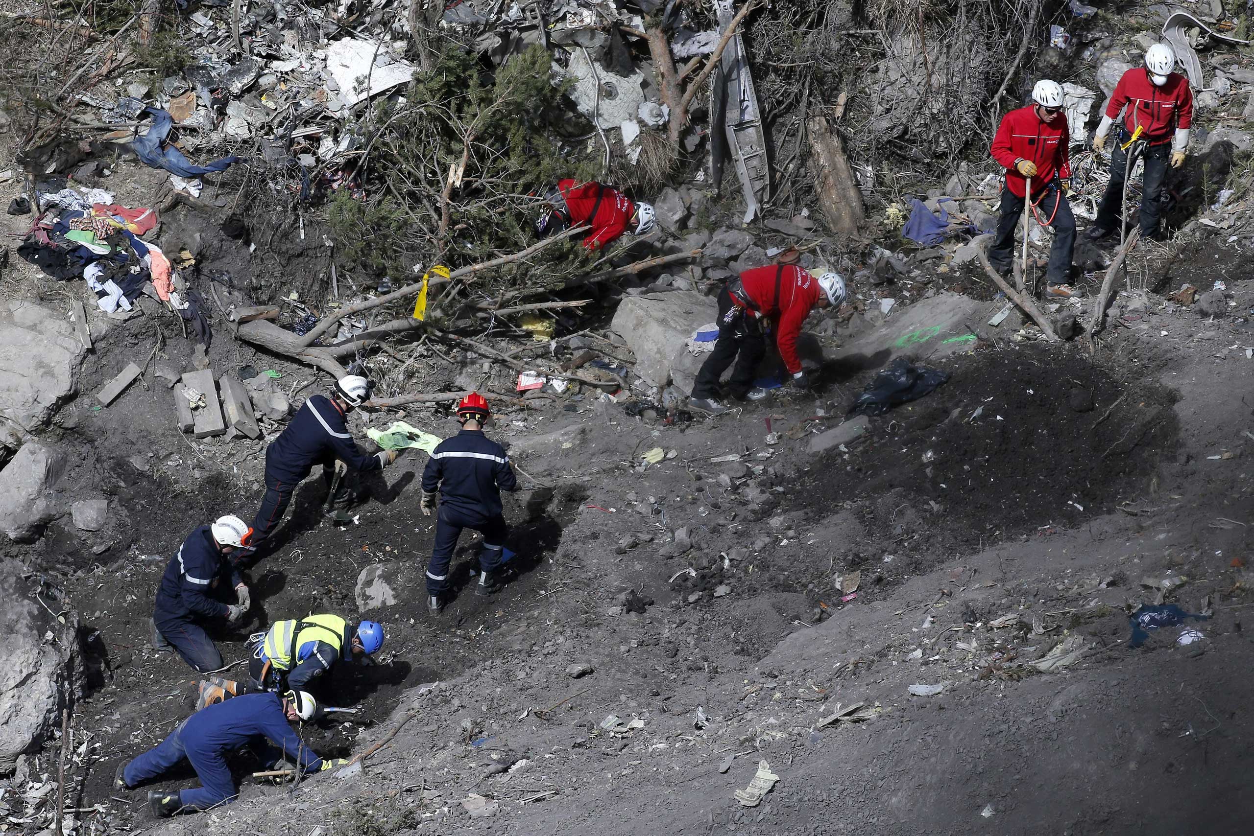 Searchers work to collect debris and find the second black box resume at the crash site of the Germanwings Airbus A320 in the French Alps, above the town of Seyne-les-Alpes, southeastern France, March 29, 2015.