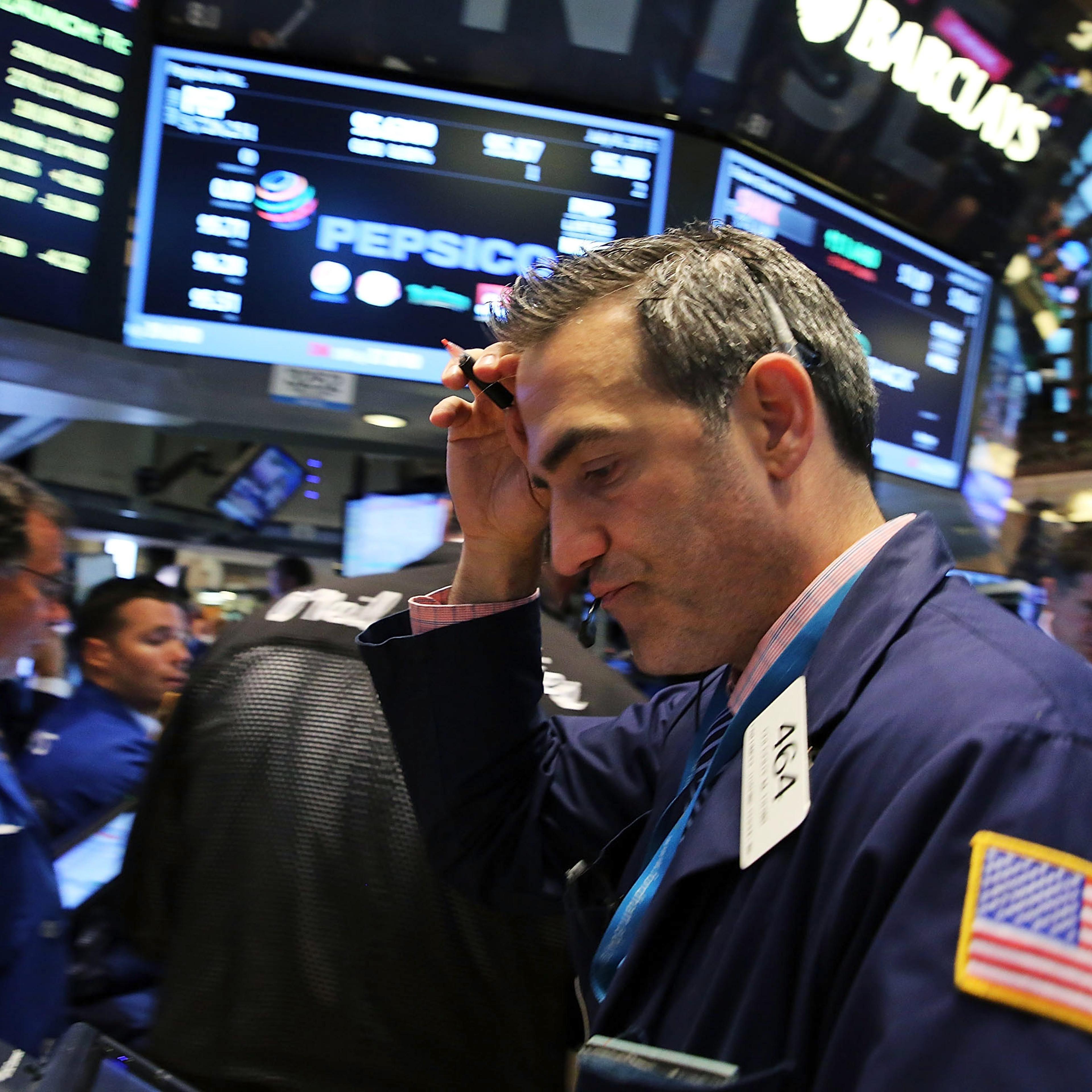 NEW YORK, NY - JULY 08: Traders work on the floor of the New York Stock Exchange (NYSE) at the close of the day after trading was resumed an over three hour closure of the market due to a "technical glitch" on July 8, 2015 in New York City. Trading was