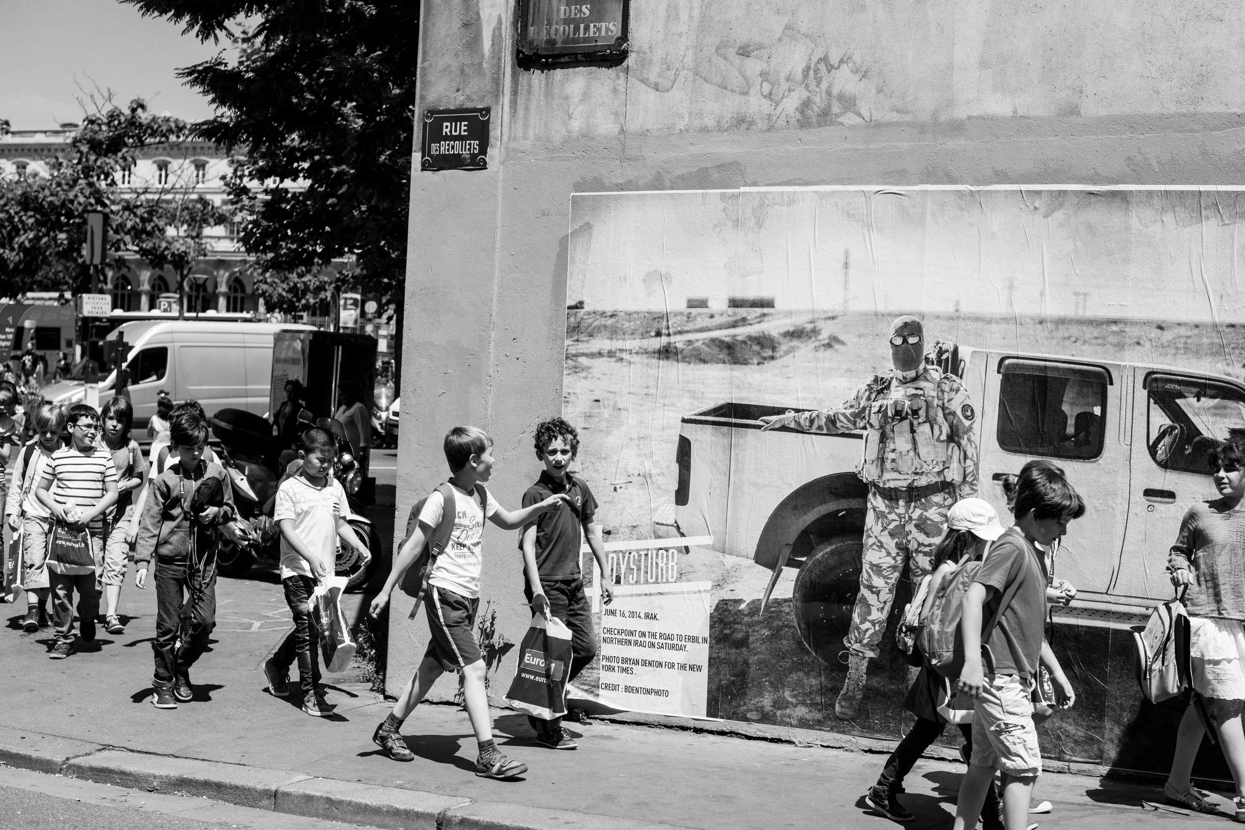 Dysturb pasting photographs on walls