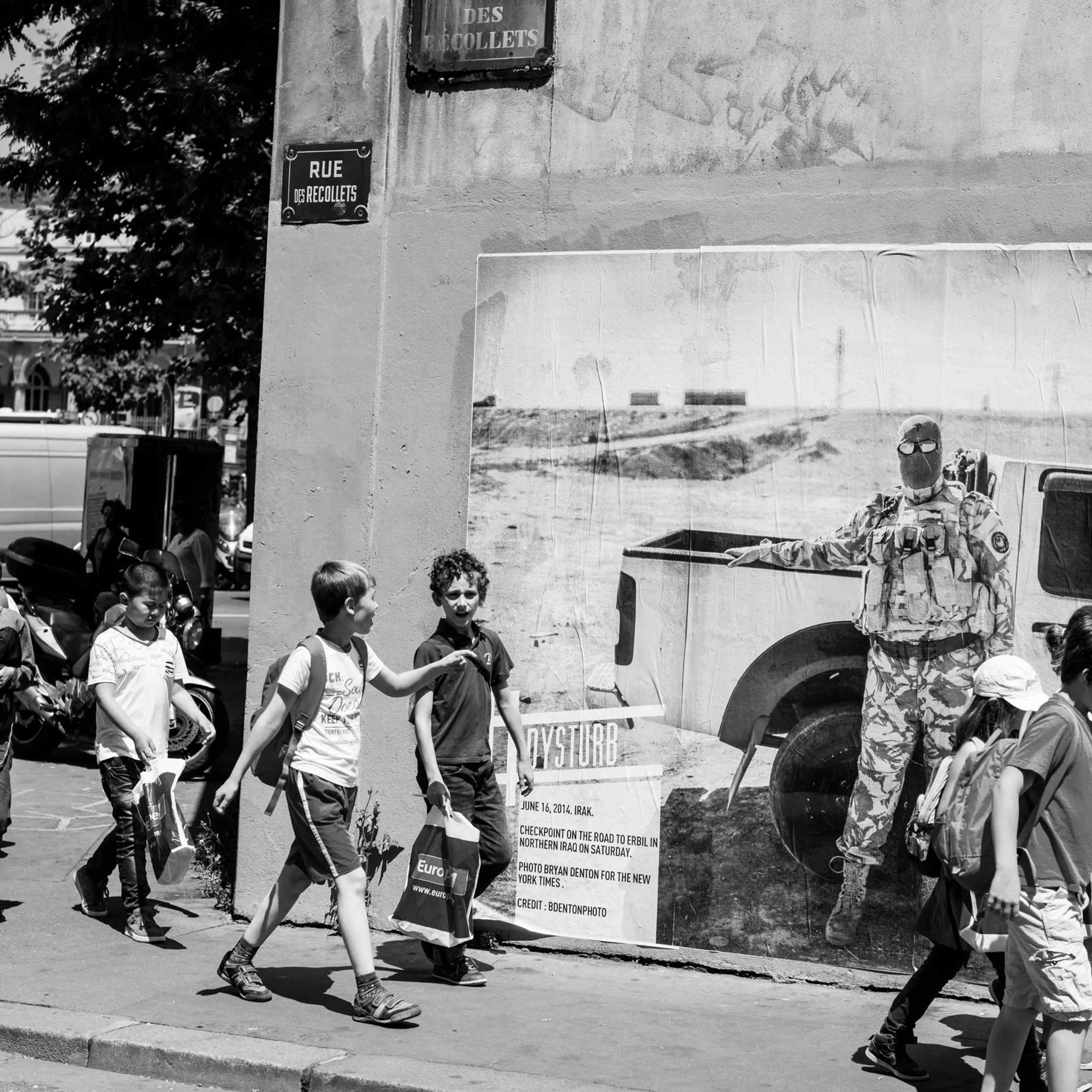 Dysturb pasting photographs on walls