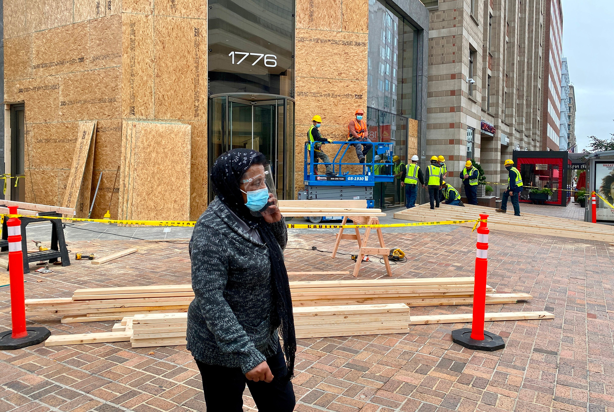 Workers install protections on building facades near the White House as building managers and local businesses fear violent demonstrations ahead of the coming Presidential elections, on Oct. 26