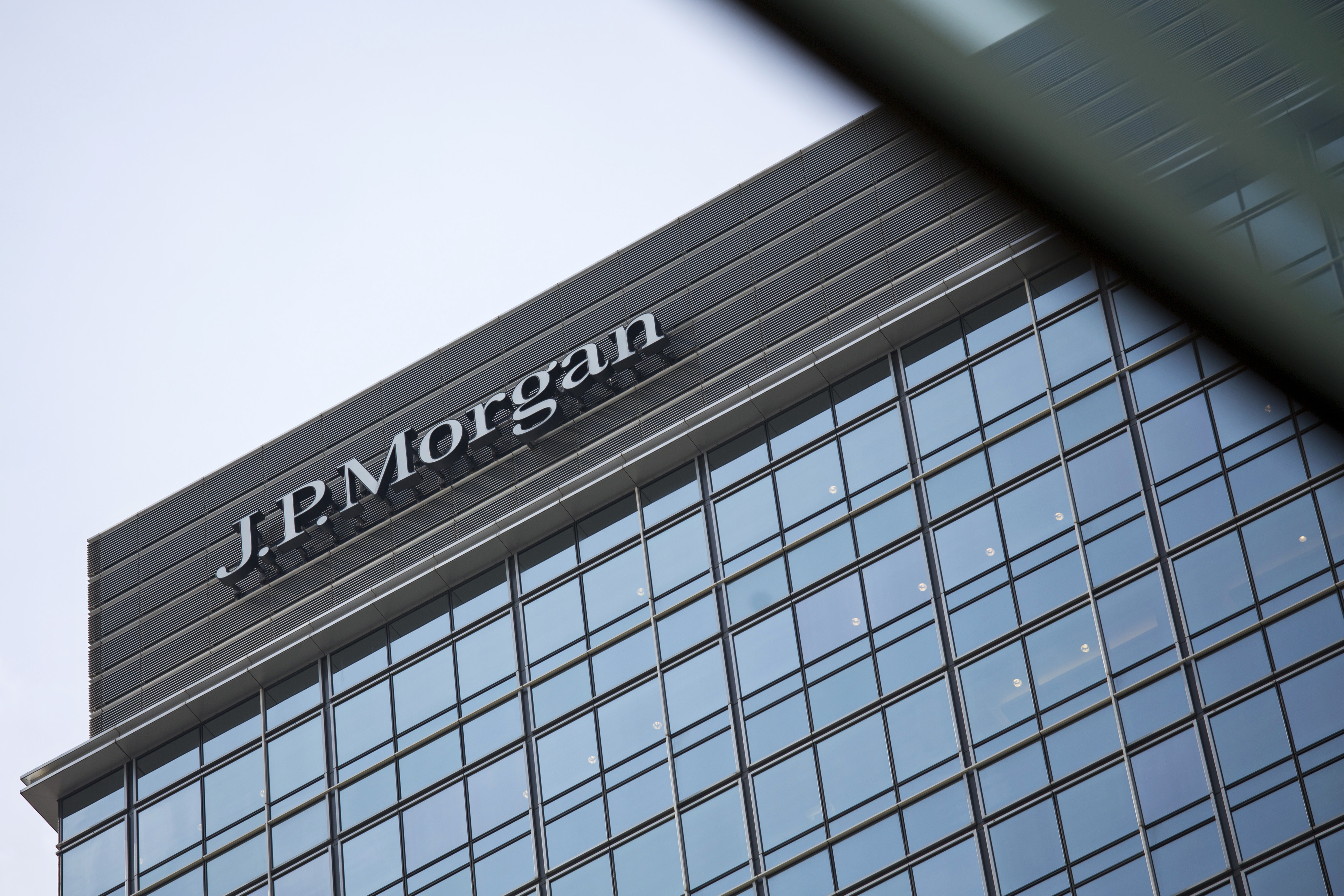 Signage for JPMorgan Chase & Co. is displayed atop Chater House in the central business district of Hong Kong on Aug. 29, 2013.
