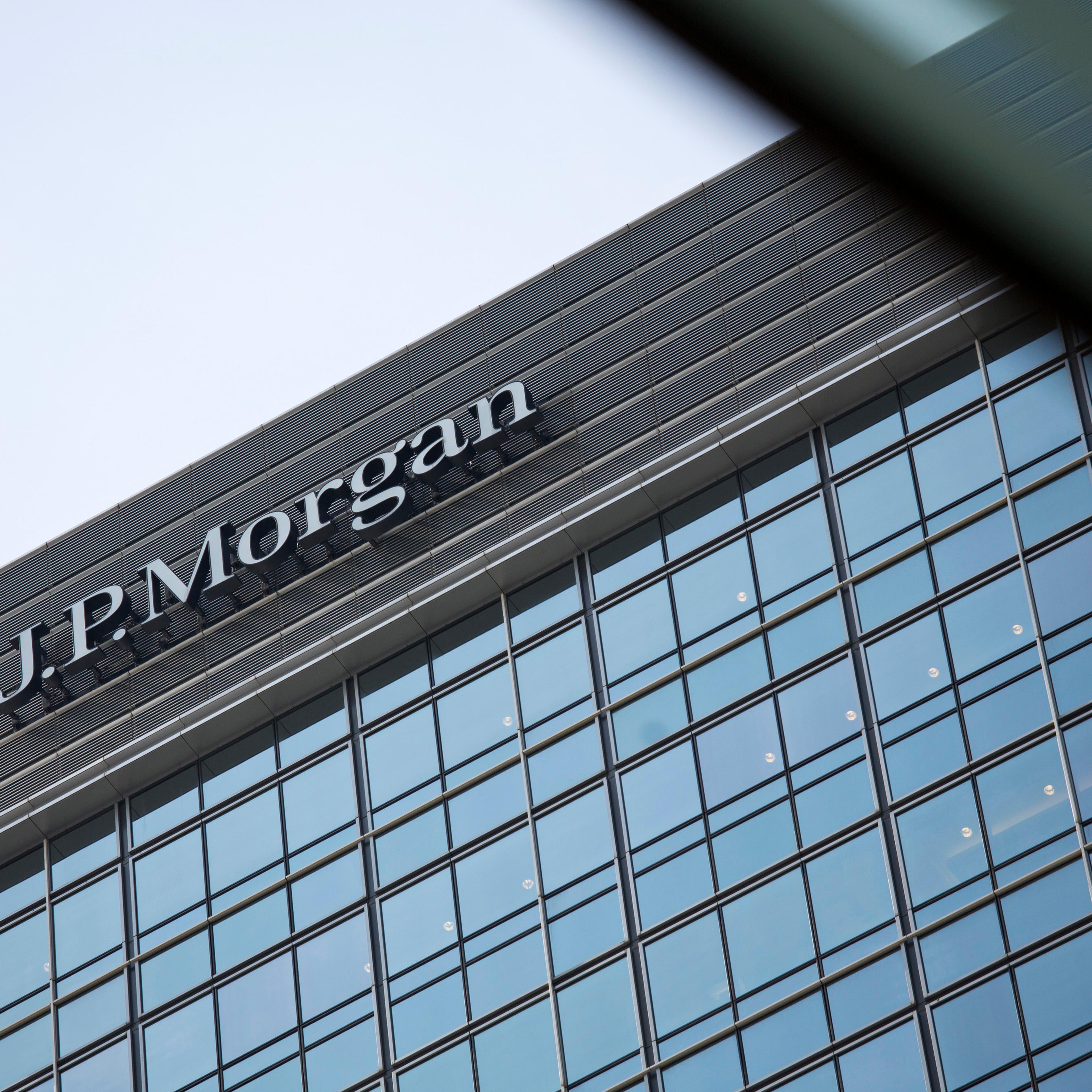 Signage for JPMorgan Chase & Co. is displayed atop Chater House in the central business district of Hong Kong on Aug. 29, 2013.
