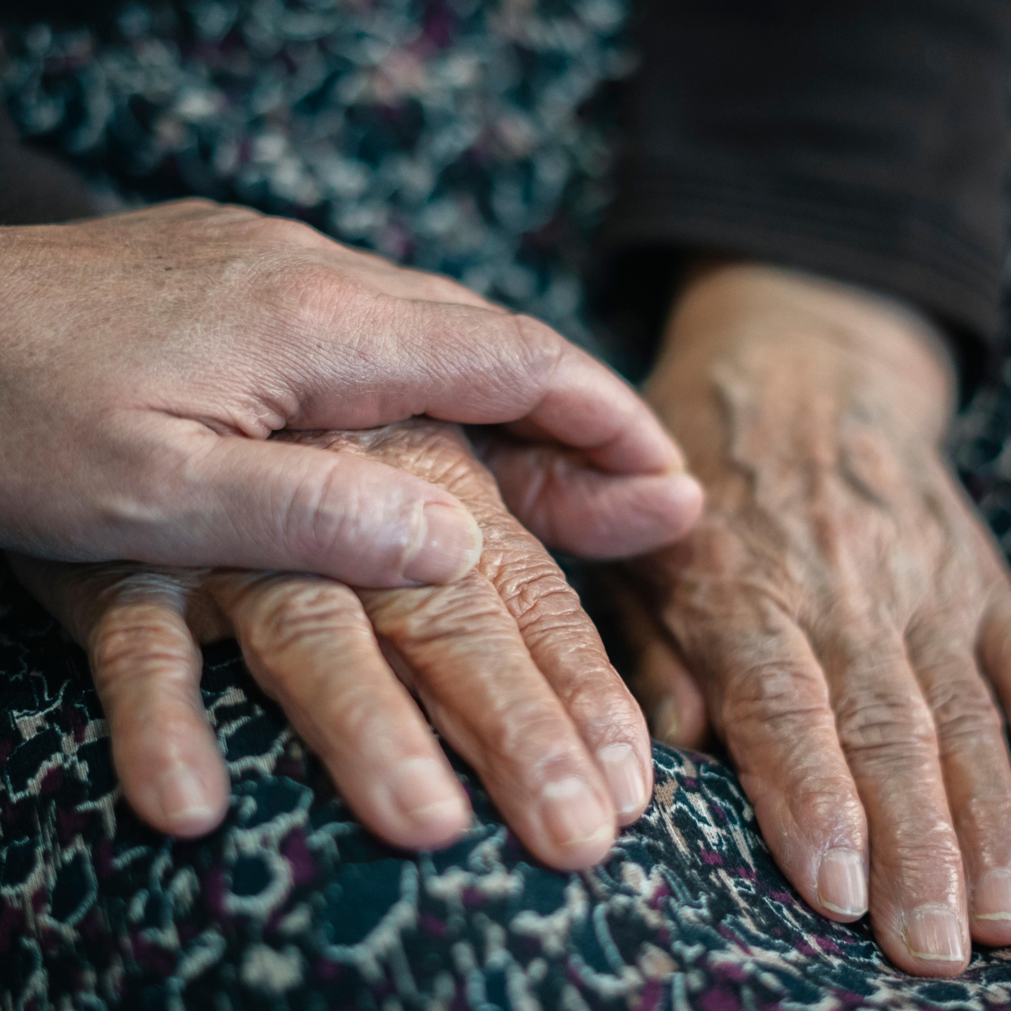 Close-up Adult woman and old woman holding hands