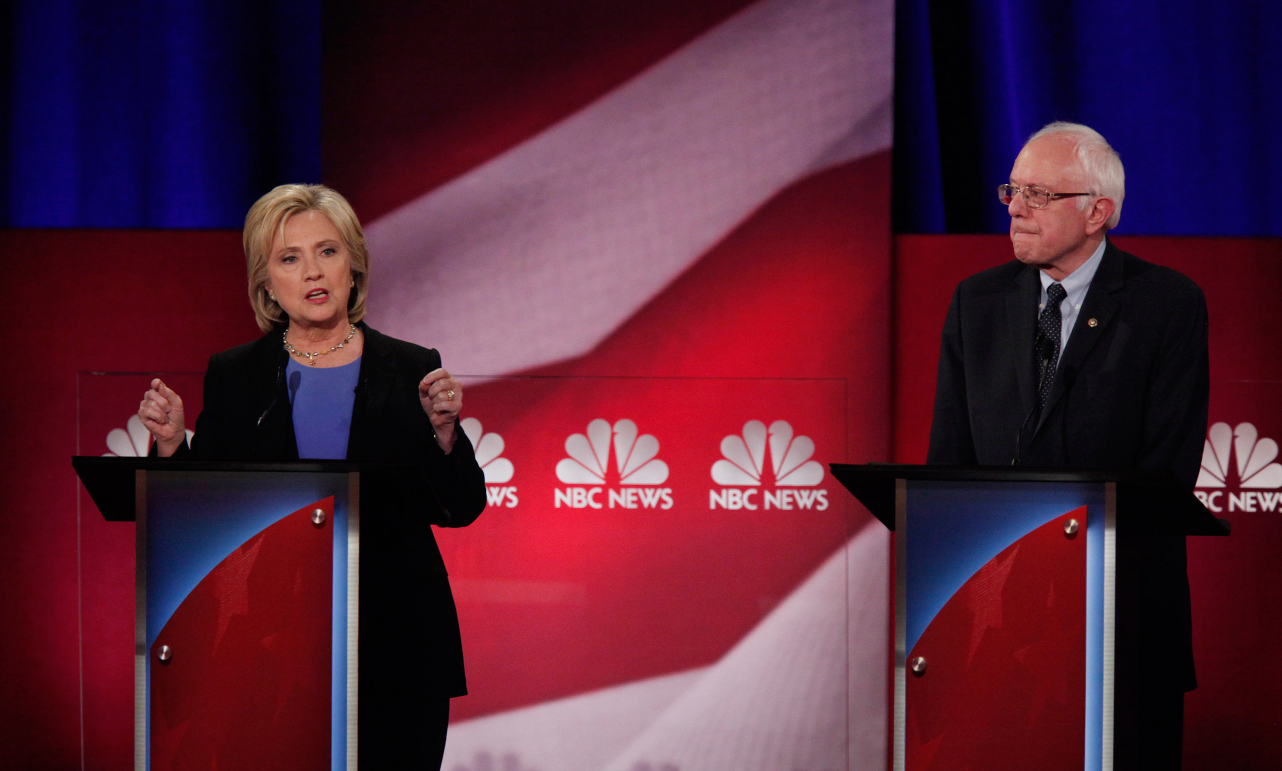 Democratic U.S. presidential candidate and former Secretary of State Hillary Clinton speaks as rival U.S. Senator Bernie Sanders listens at the NBC News - YouTube Democratic presidential candidates debate in Charleston, South Carolina January 17, 2016. R