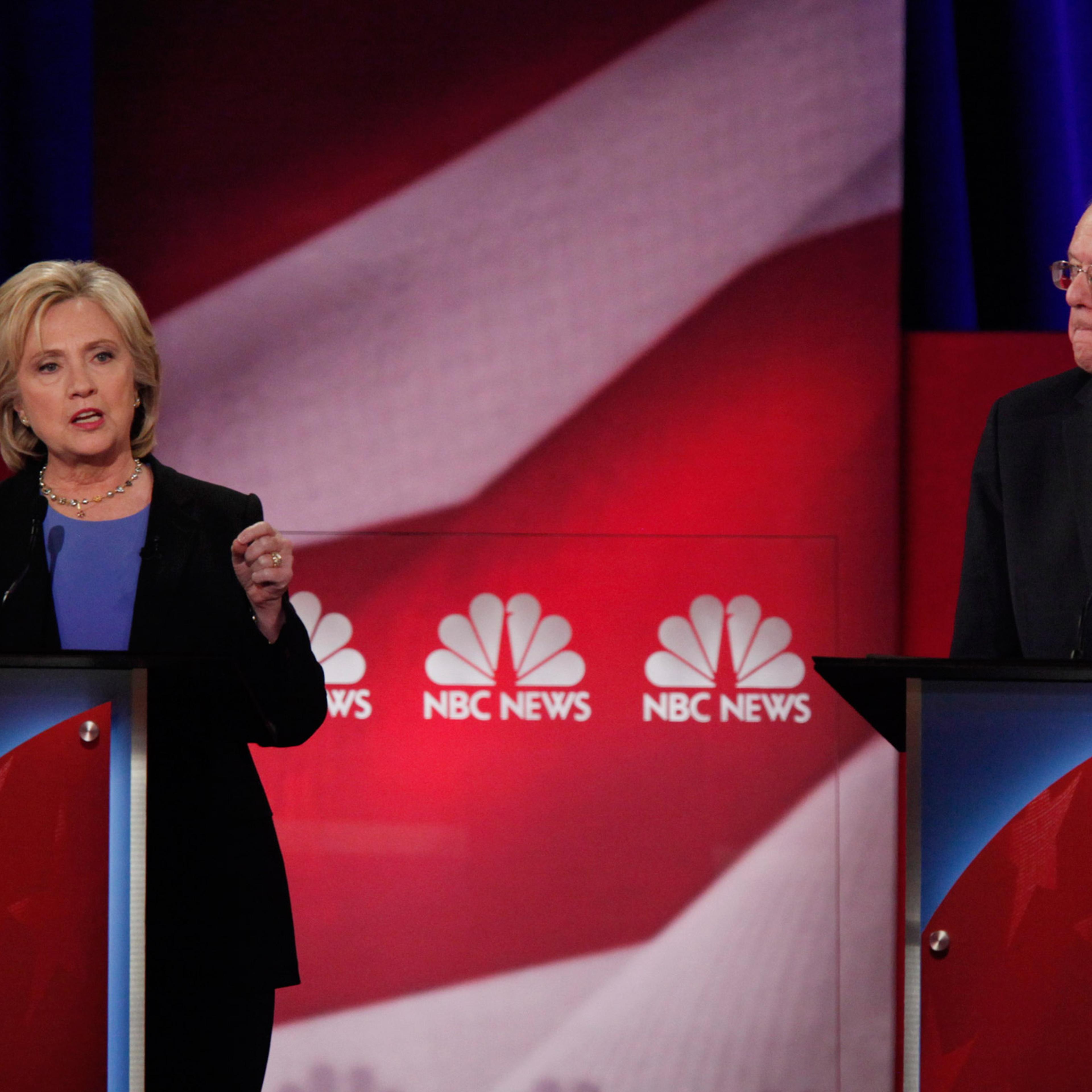 Democratic U.S. presidential candidate and former Secretary of State Hillary Clinton speaks as rival U.S. Senator Bernie Sanders listens at the NBC News - YouTube Democratic presidential candidates debate in Charleston, South Carolina January 17, 2016. R