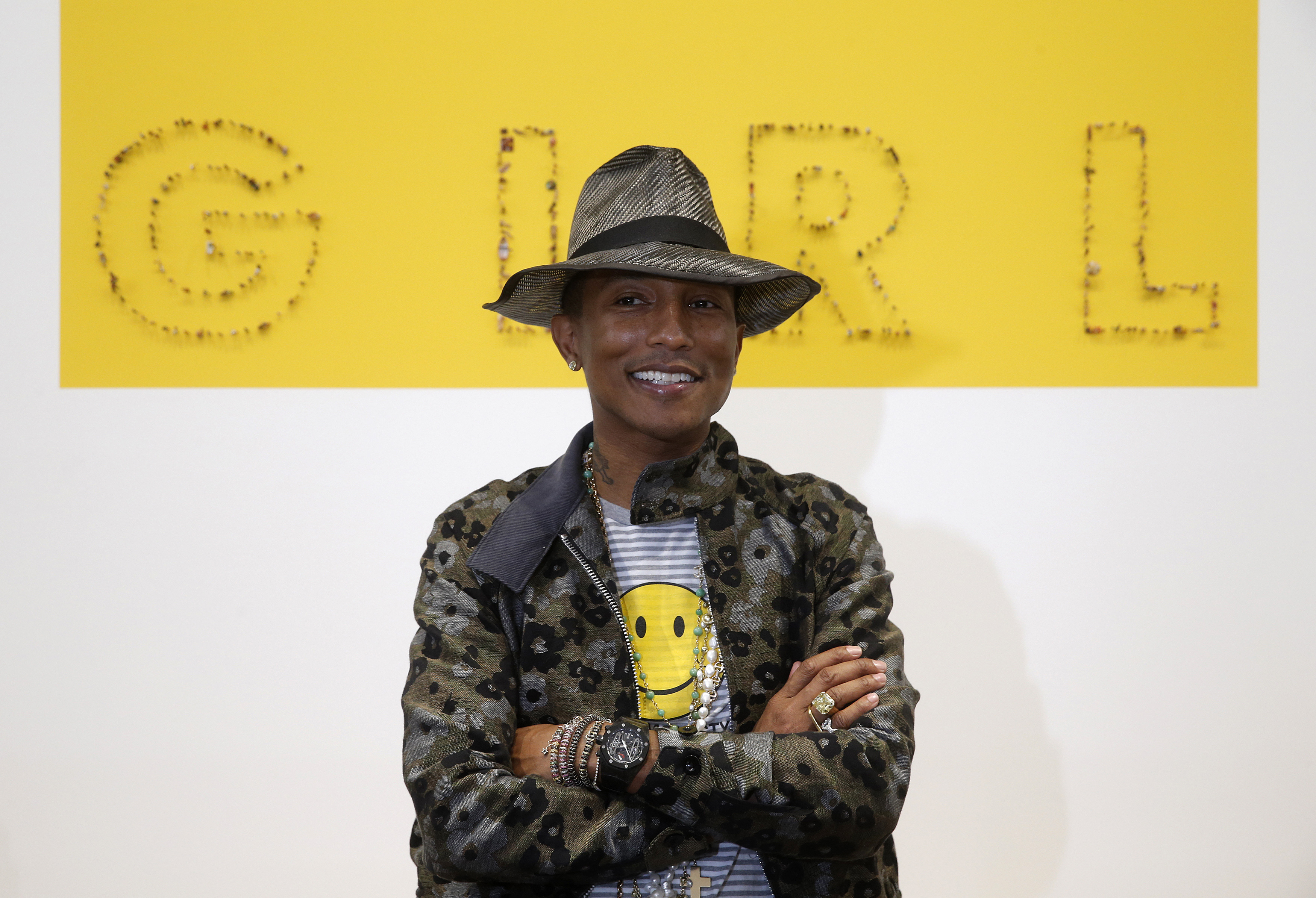 Singer Pharrell Williams poses during the opening of the exhibition "GIRL" at the Galerie Perrotin in Paris