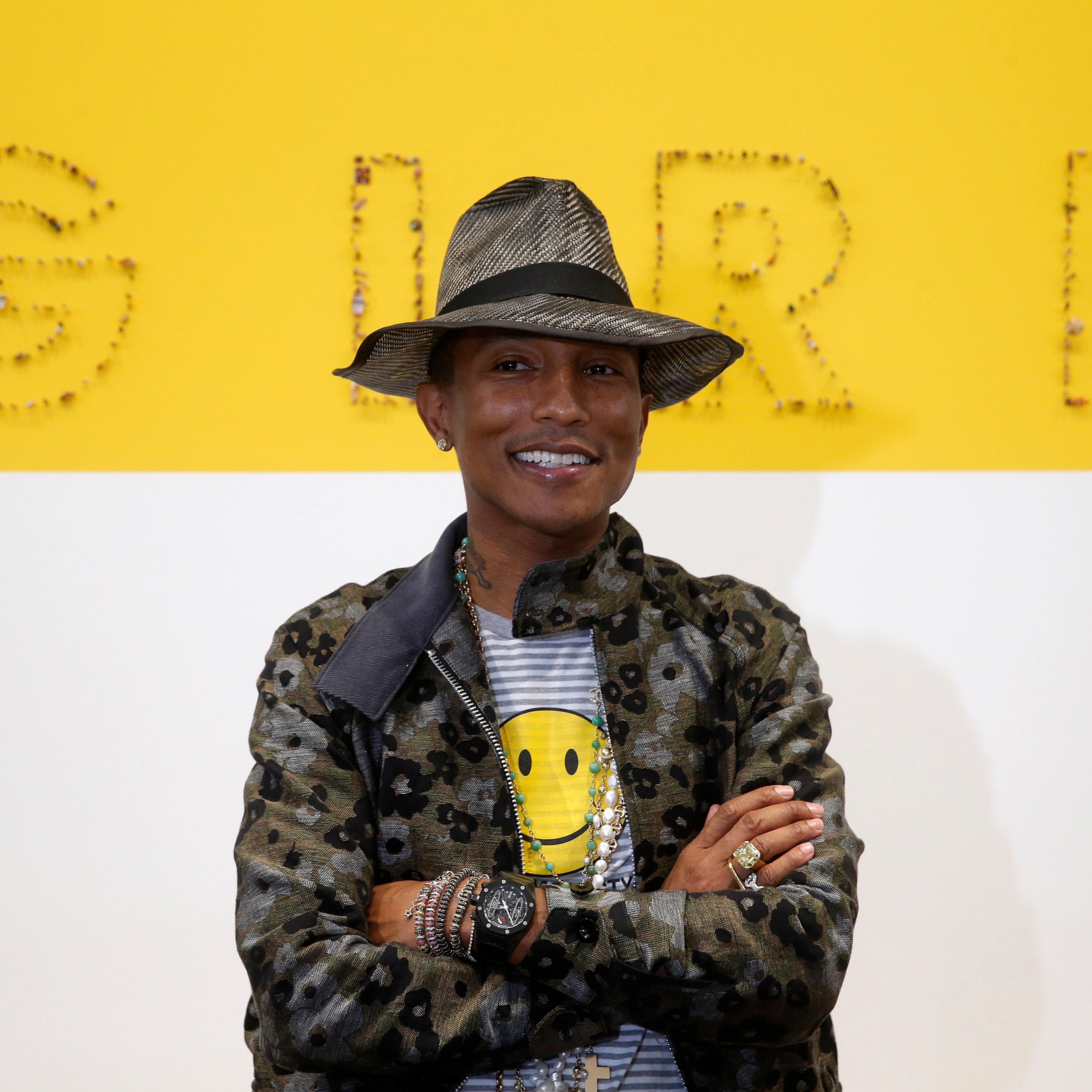 Singer Pharrell Williams poses during the opening of the exhibition "GIRL" at the Galerie Perrotin in Paris