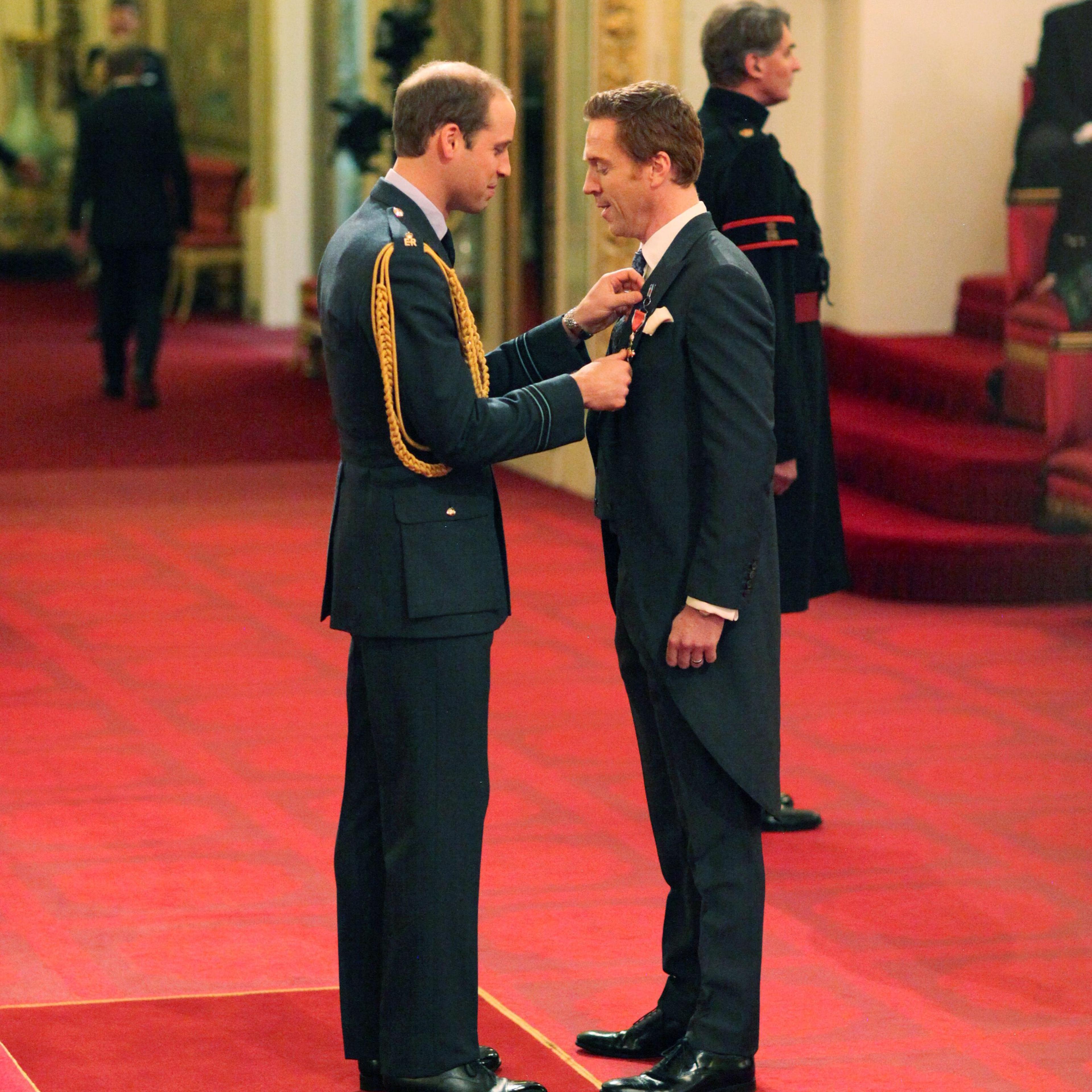 Investitures at Buckingham Palace. Damian Lewis from London is made an Officer of the Order of the British Empire (OBE) by the Duke of Cambridge during an Investiture ceremony at Buckingham Palace on Nov. 26, 2014.