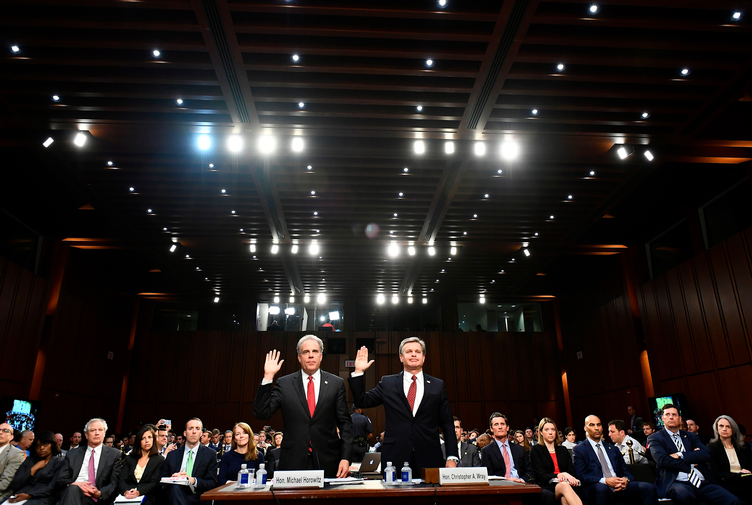 Justice Department Inspector General Michael Horowitz, left, and FBI Director Christopher Wray take an oath before testifying to the Senate Judiciary Committee in Washington, DC on June 18, 2018.
